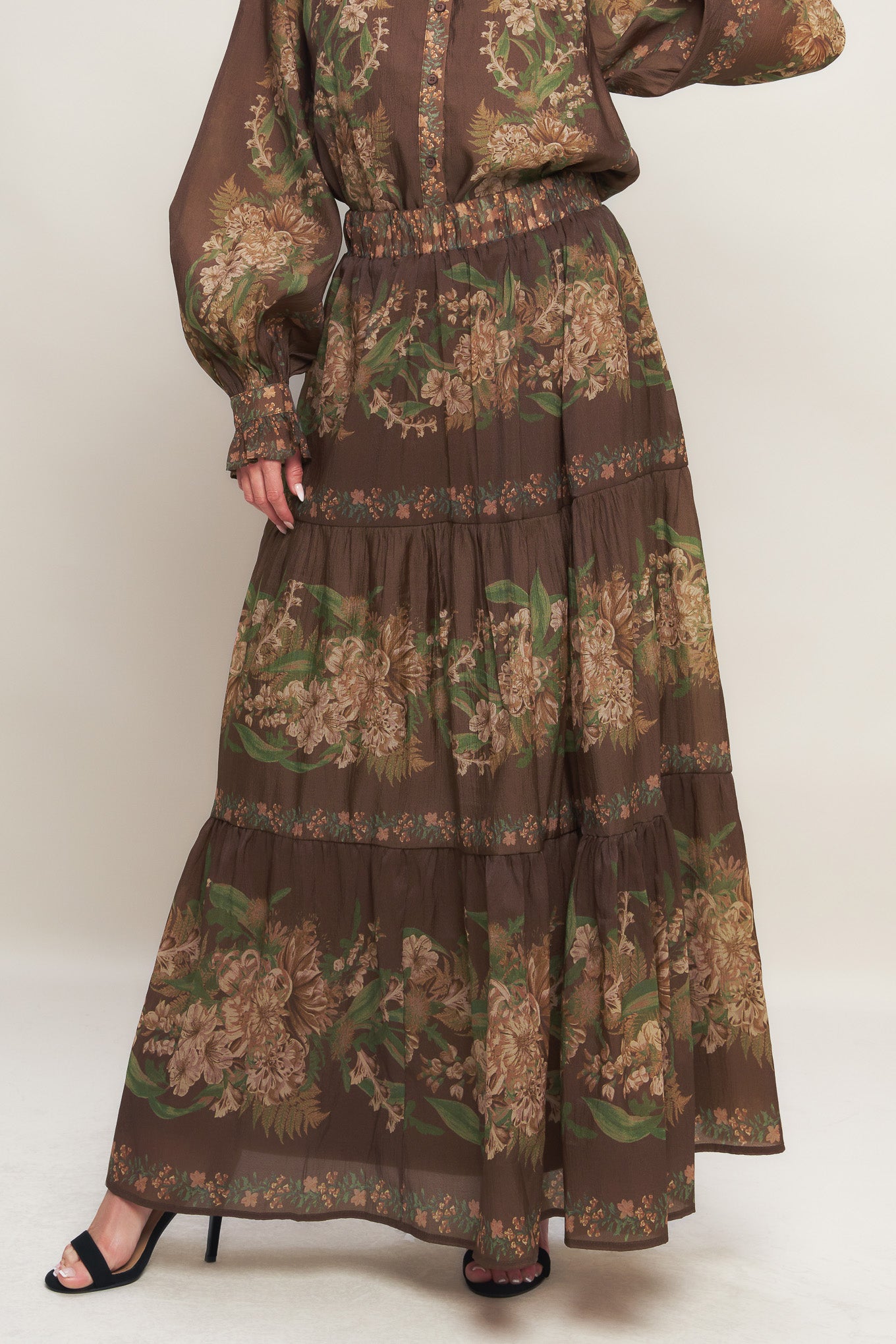 A printed woven maxi skirt featuring elasticized waist and tiers