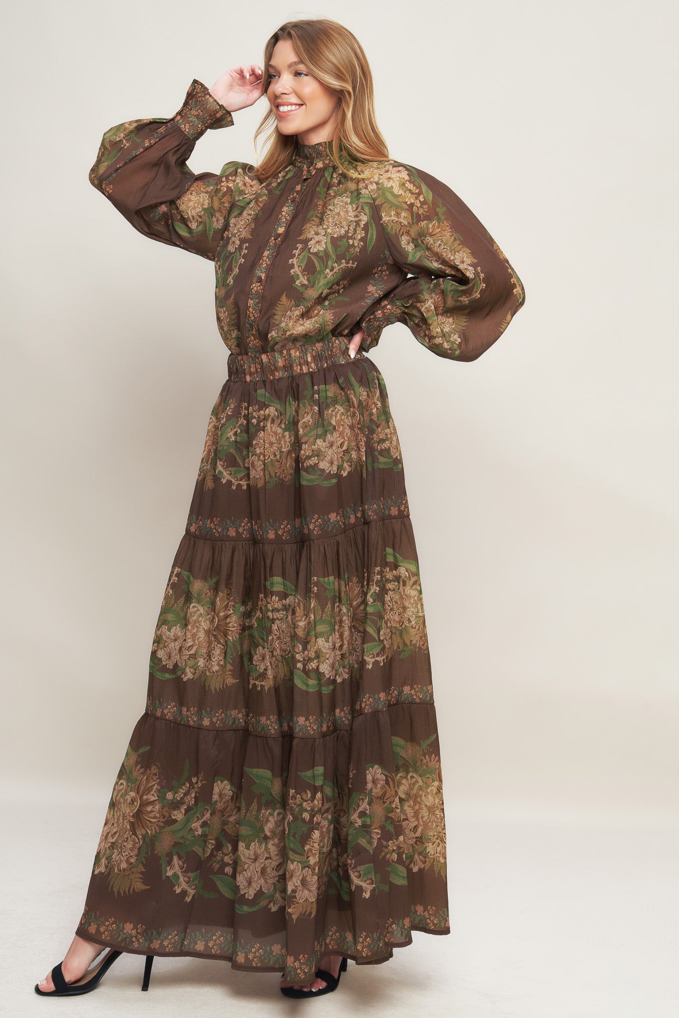 A printed woven maxi skirt featuring elasticized waist and tiers