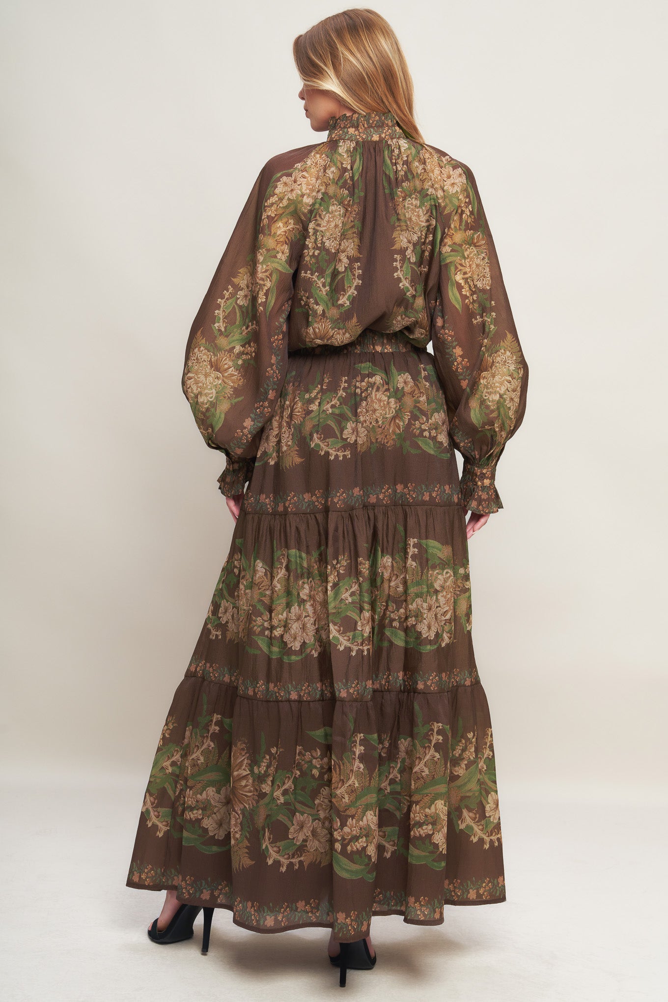 A printed woven maxi skirt featuring elasticized waist and tiers