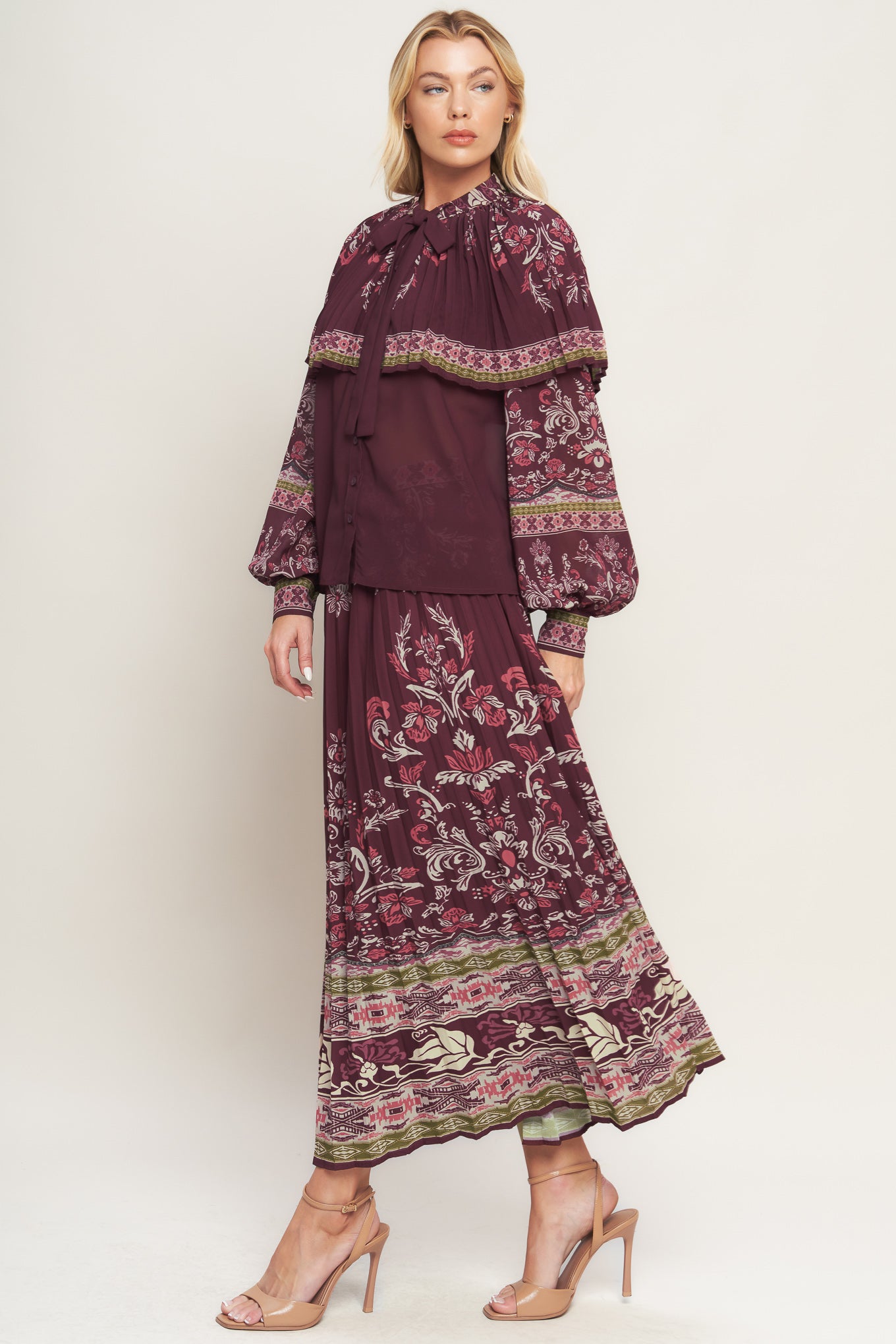 A printed woven pleated midi skirt with side zipper closure. Matching top IT13890