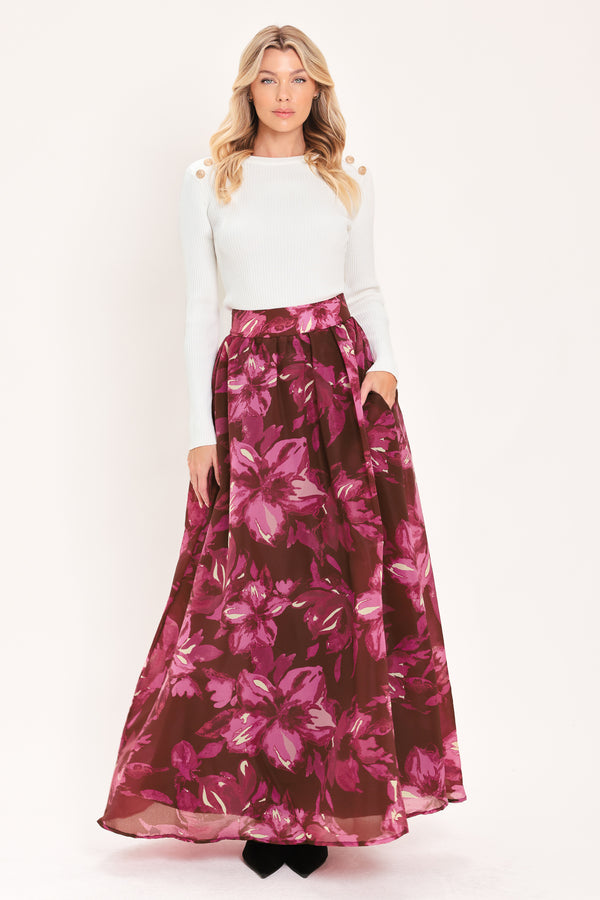 A model wearing a high-waisted, floor-length maxi A-line skirt with a dark burgundy base and a vibrant magenta floral pattern | Flying Tomato