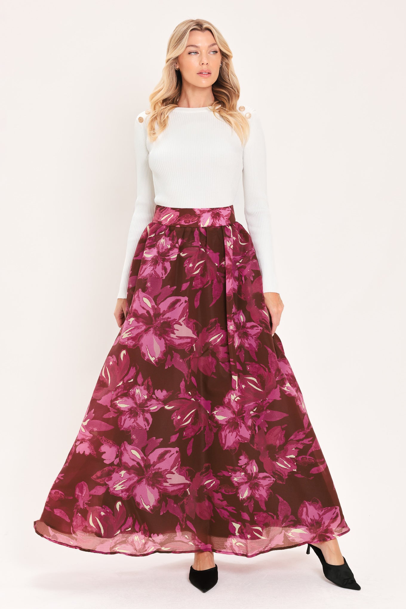 A model wearing a high-waisted, floor-length maxi A-line skirt with a dark burgundy base and a vibrant magenta floral pattern | Flying Tomato
