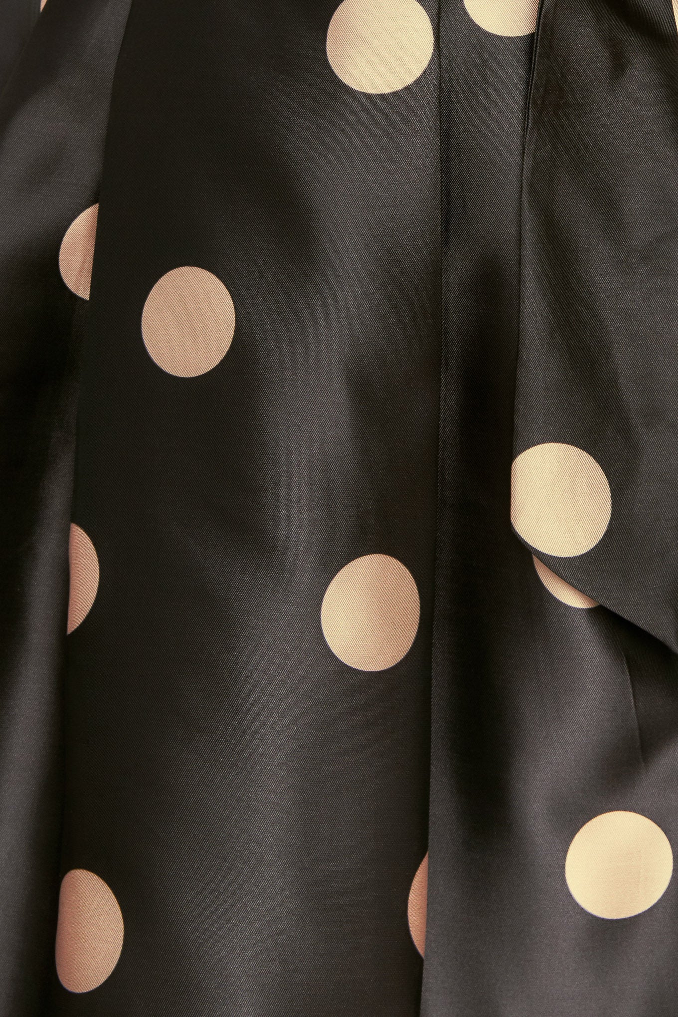 A polka-dotted printed woven full midi skirt featuring side zipper closure with tie.