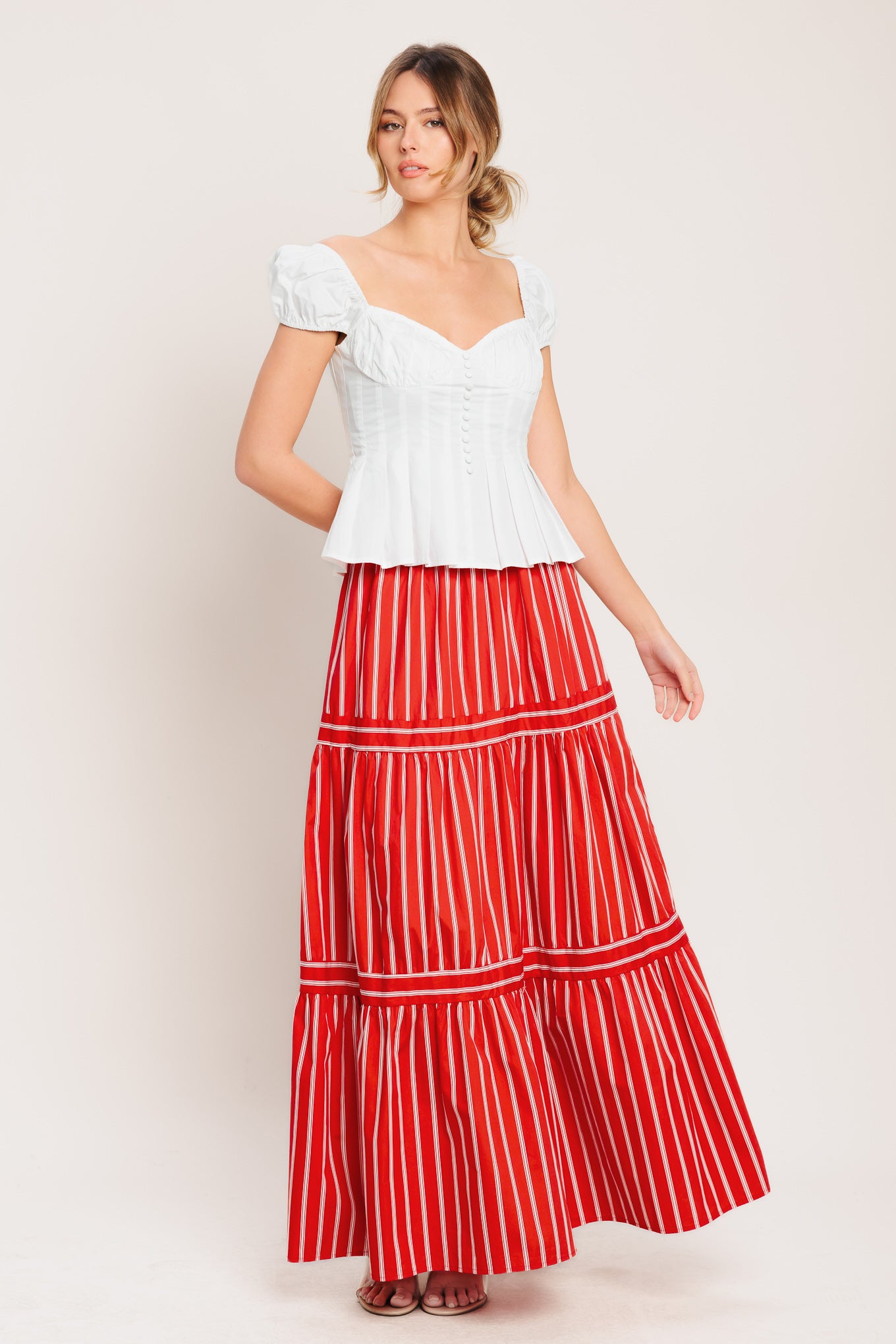 A striped woven maxi skirt with elastic waist and tiered skirt. Matching top IT13960B

Details:

Self: 100% Cotton

Lining: 100% Polyester

Size & Fit

-Model is 5`8" And Wearing Size Small
-Measurements Taken From Size Small
-Approx. Length: 42"