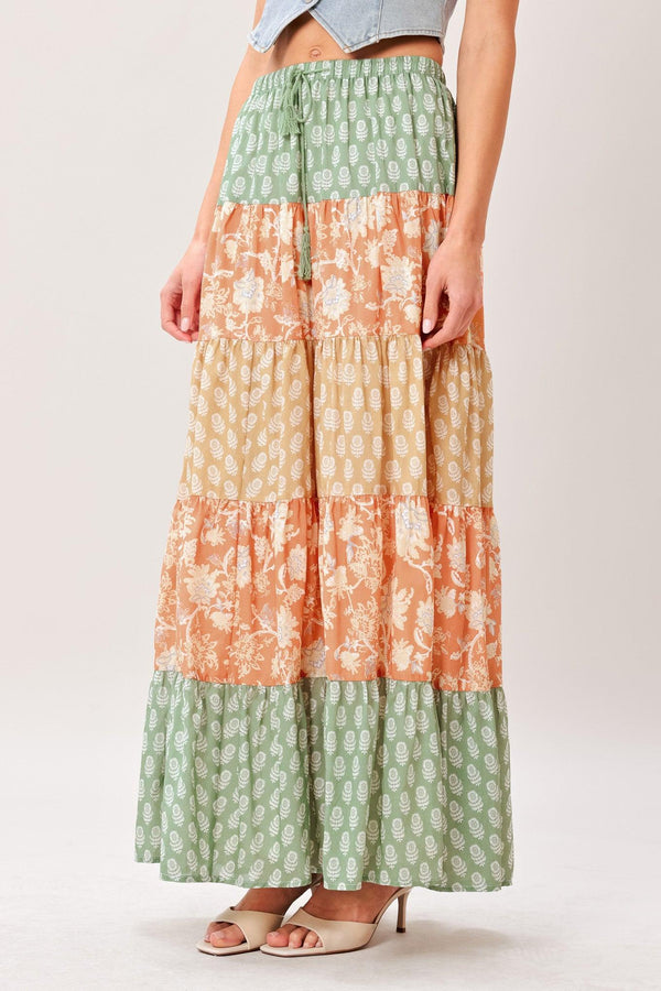 Long, patterned skirt with a gradient from green to orange on a plain background