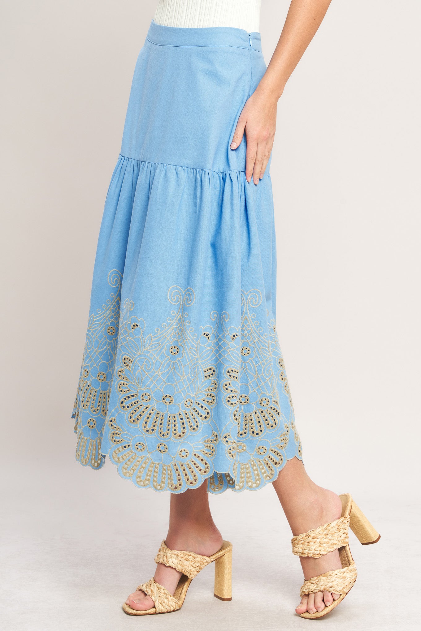 Light blue skirt with lace details worn by a person on a plain background