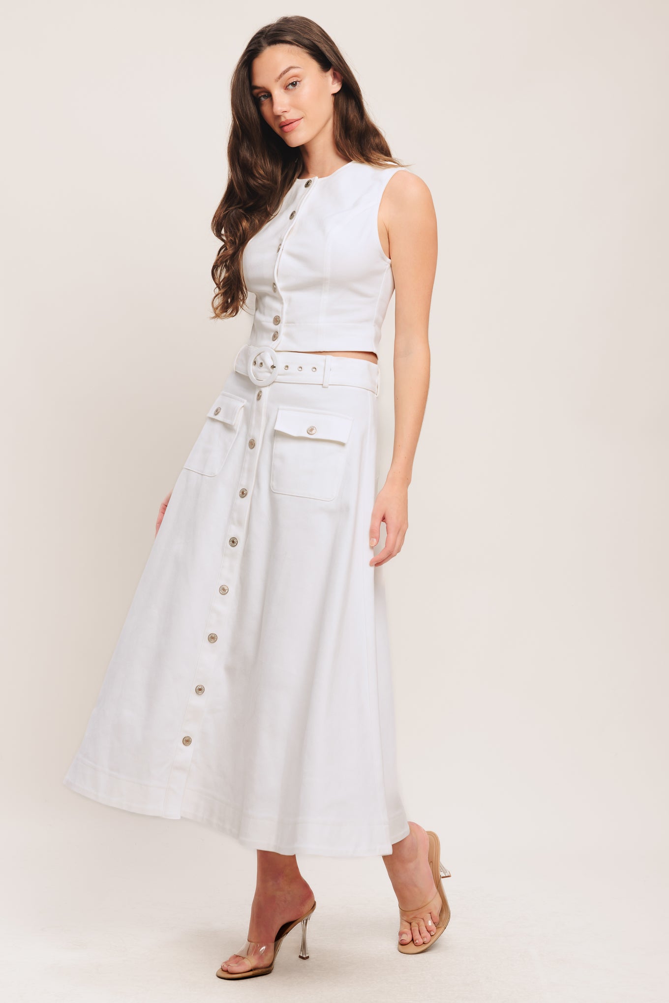 A solid woven midi skirt featuring self belt, front button down and pockets. Matching top IT14089B

Details:

Self: 97% Cotton 3% Spandex

Size & Fit

-Model is 5`8" And Wearing Size Small
-Measurements Taken From Size Small
-Approx. Length: 34"