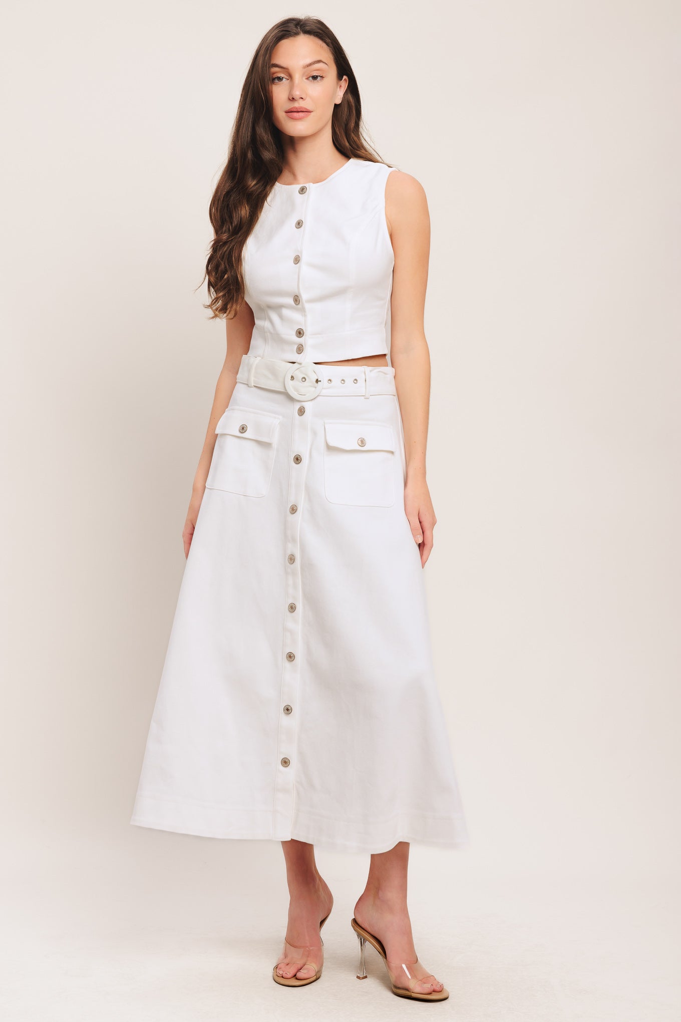A solid woven midi skirt featuring self belt, front button down and pockets. Matching top IT14089B

Details:

Self: 97% Cotton 3% Spandex

Size & Fit

-Model is 5`8" And Wearing Size Small
-Measurements Taken From Size Small
-Approx. Length: 34"