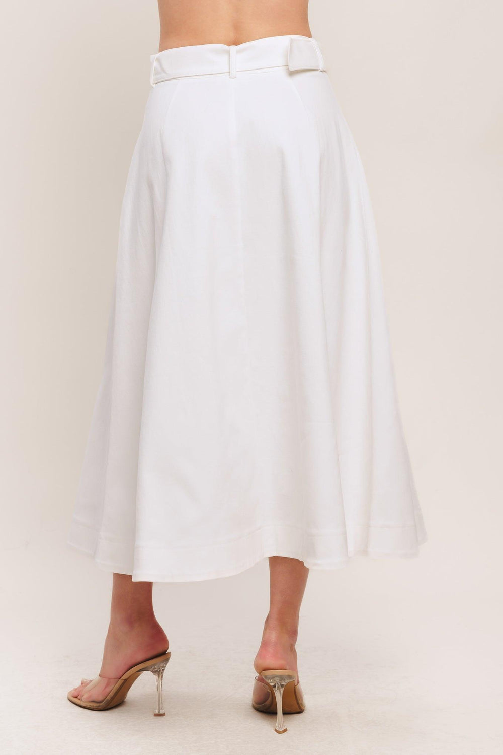 A solid woven midi skirt featuring self belt, front button down and pockets. Matching top IT14089B

Details:

Self: 97% Cotton 3% Spandex

Size & Fit

-Model is 5`8" And Wearing Size Small
-Measurements Taken From Size Small
-Approx. Length: 34"