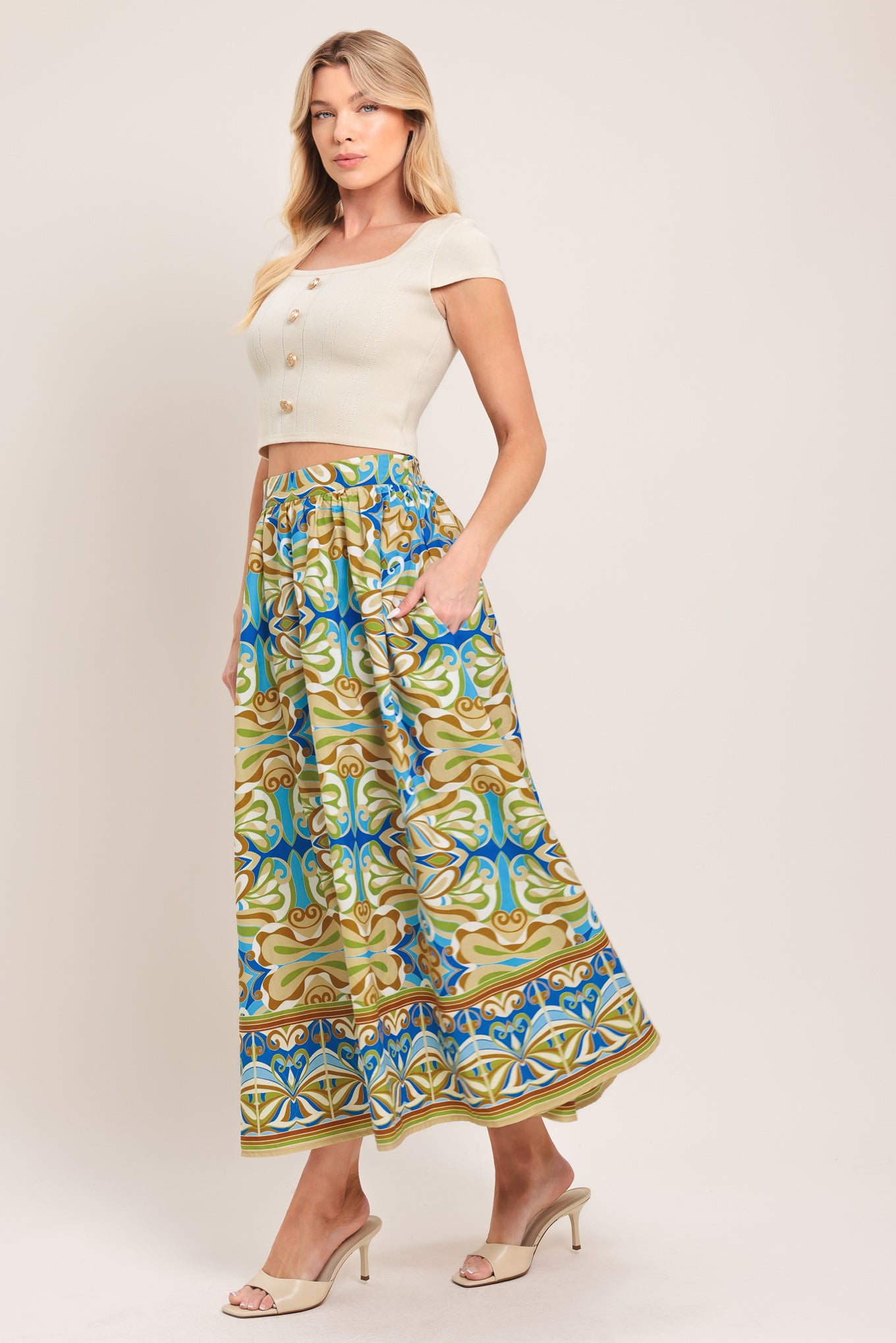 Woman wearing patterned full skirt with blue, green, and beige colors with elastic back waistband | Flying Tomato