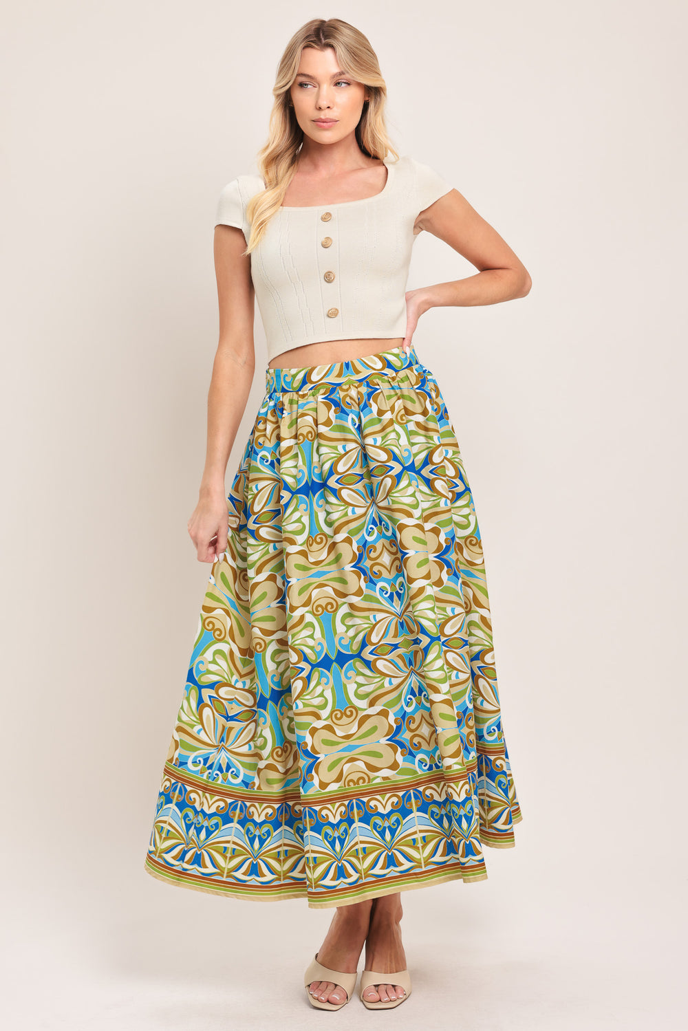 Woman wearing patterned full skirt with blue, green, and beige colors with elastic back waistband | Flying Tomato