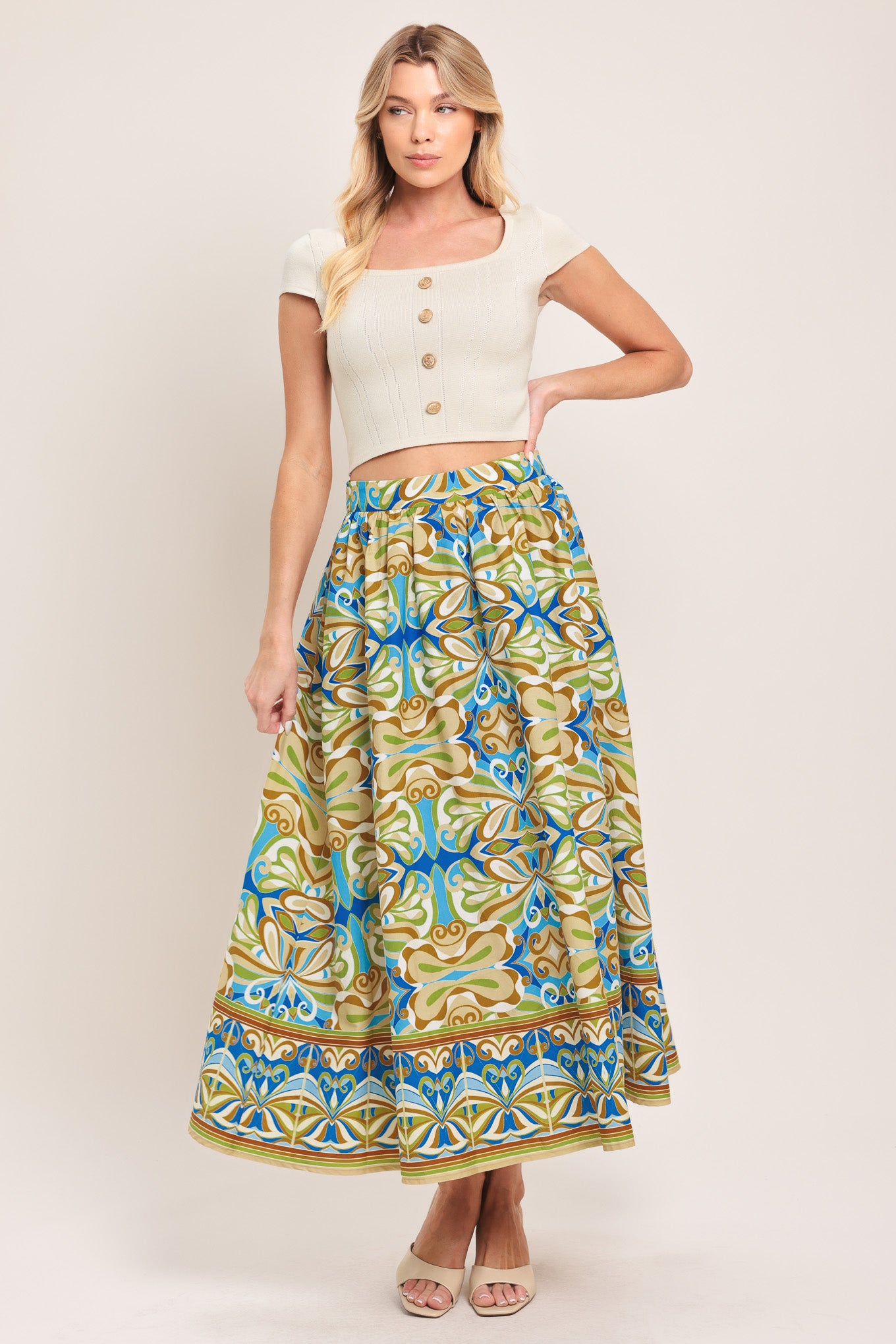 Woman wearing patterned full skirt with blue, green, and beige colors with elastic back waistband | Flying Tomato
