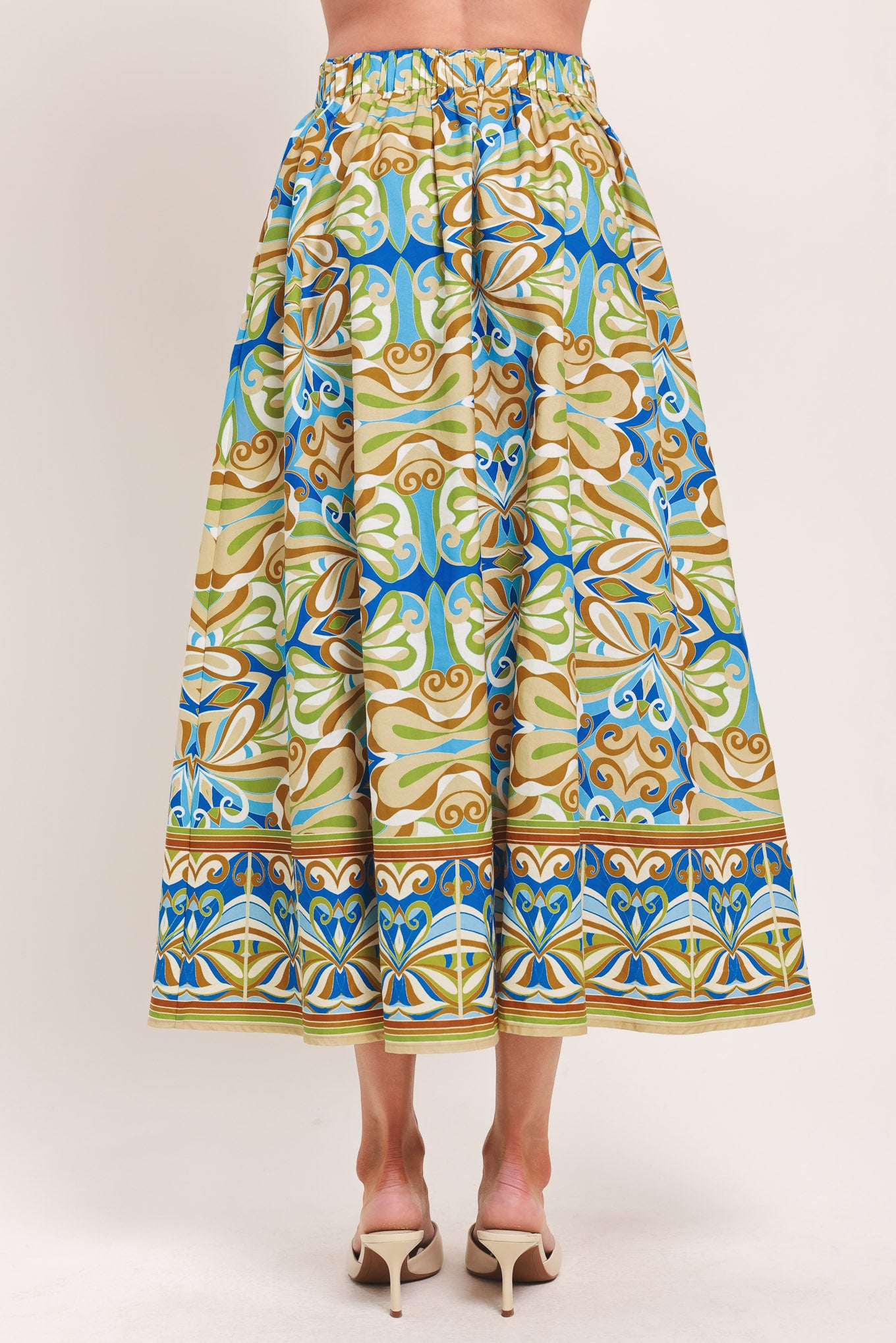 Woman wearing patterned full skirt with blue, green, and beige colors with elastic back waistband | Flying Tomato