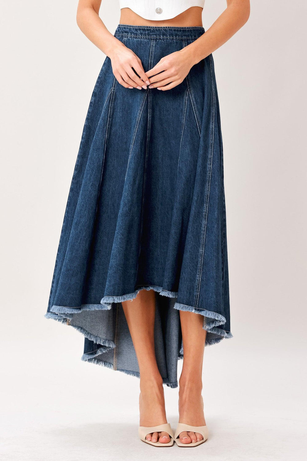 A washed denim hi-lo midi circle skirt with fray hem and back zipper closure