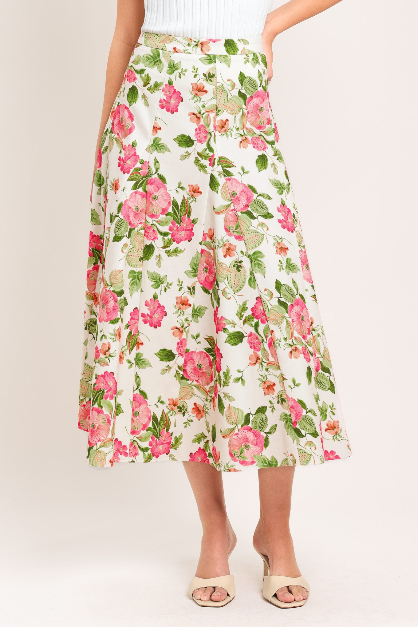 Woman wearing a floral midi skirt with side zipper closure | Flying Tomato