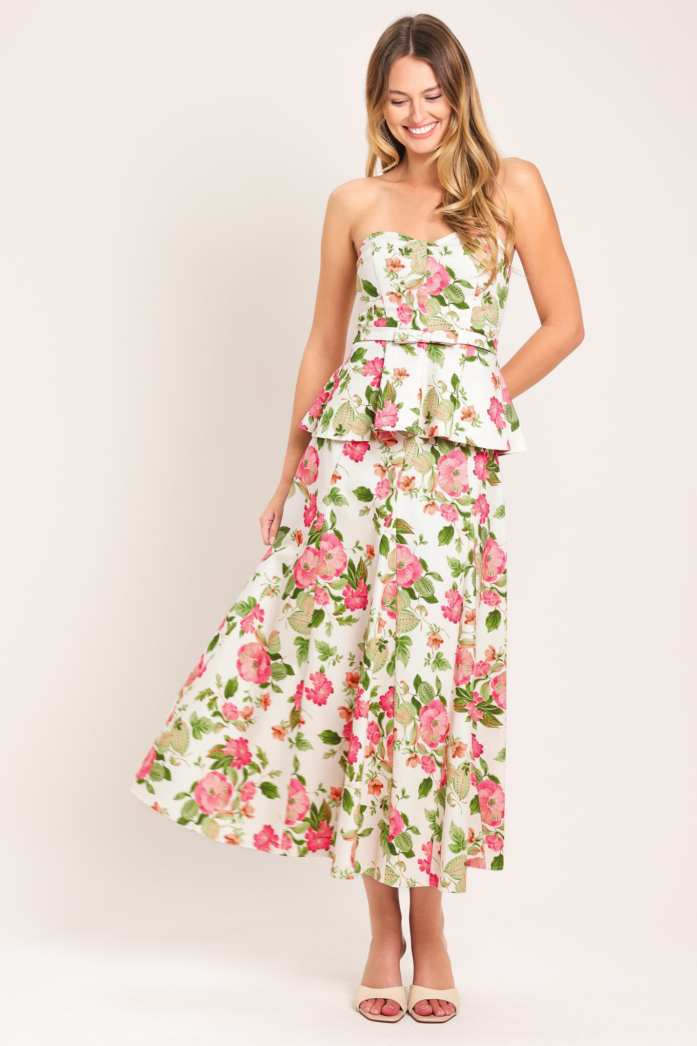 Woman wearing a floral midi skirt with side zipper closure | Flying Tomato