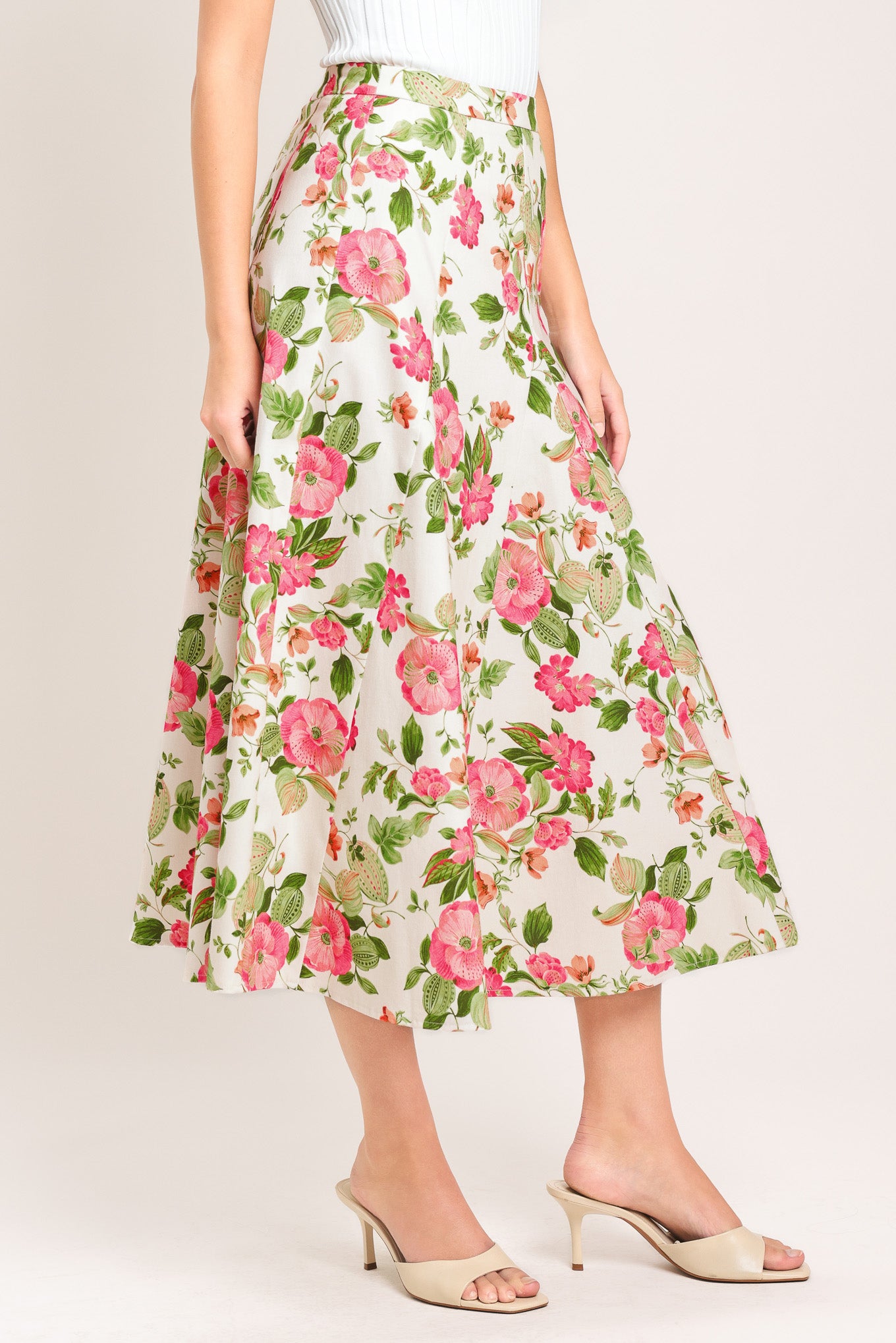 Woman wearing a floral midi skirt with side zipper closure | Flying Tomato