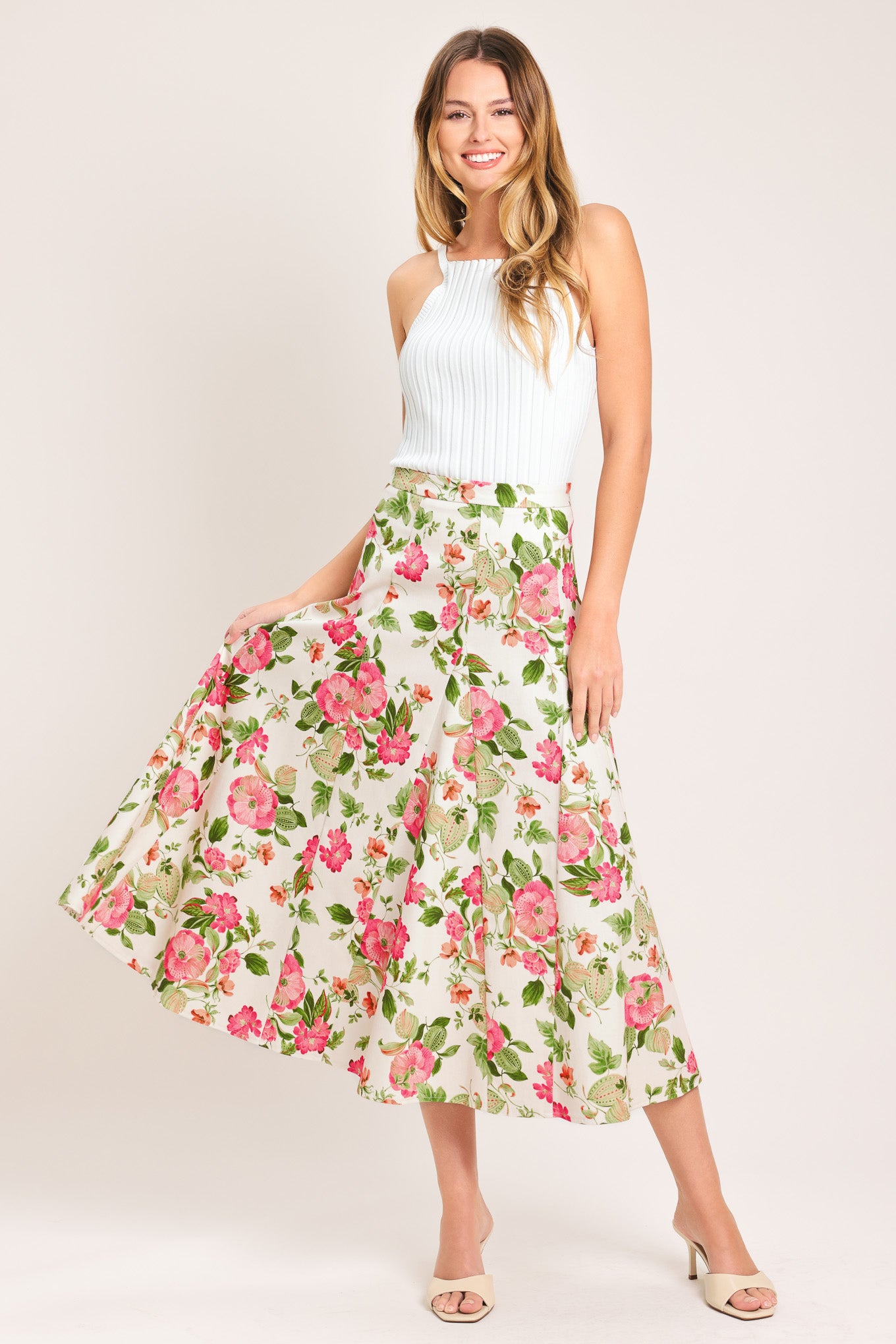 Woman wearing a floral midi skirt with side zipper closure | Flying Tomato