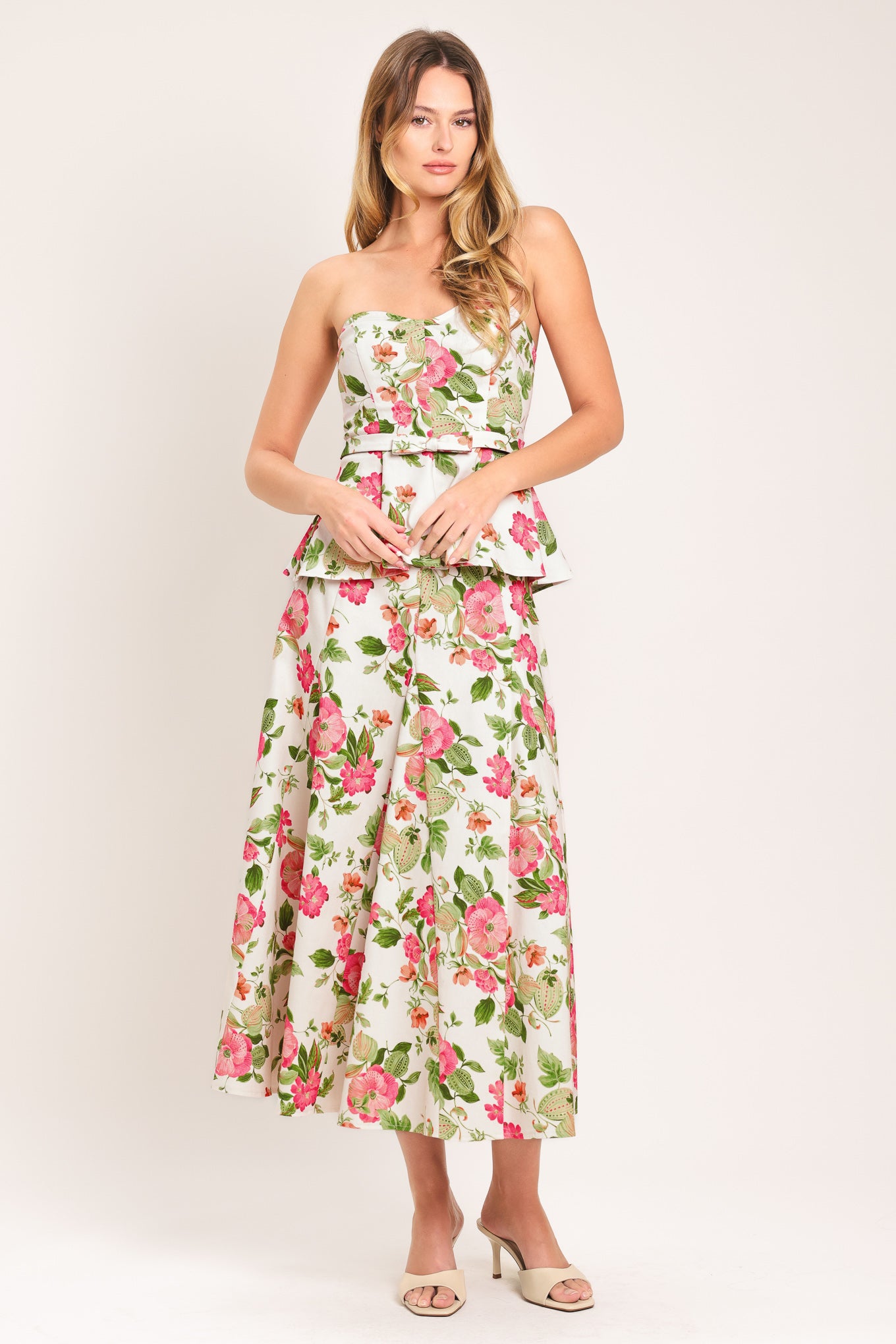 Woman wearing a floral midi skirt with side zipper closure | Flying Tomato