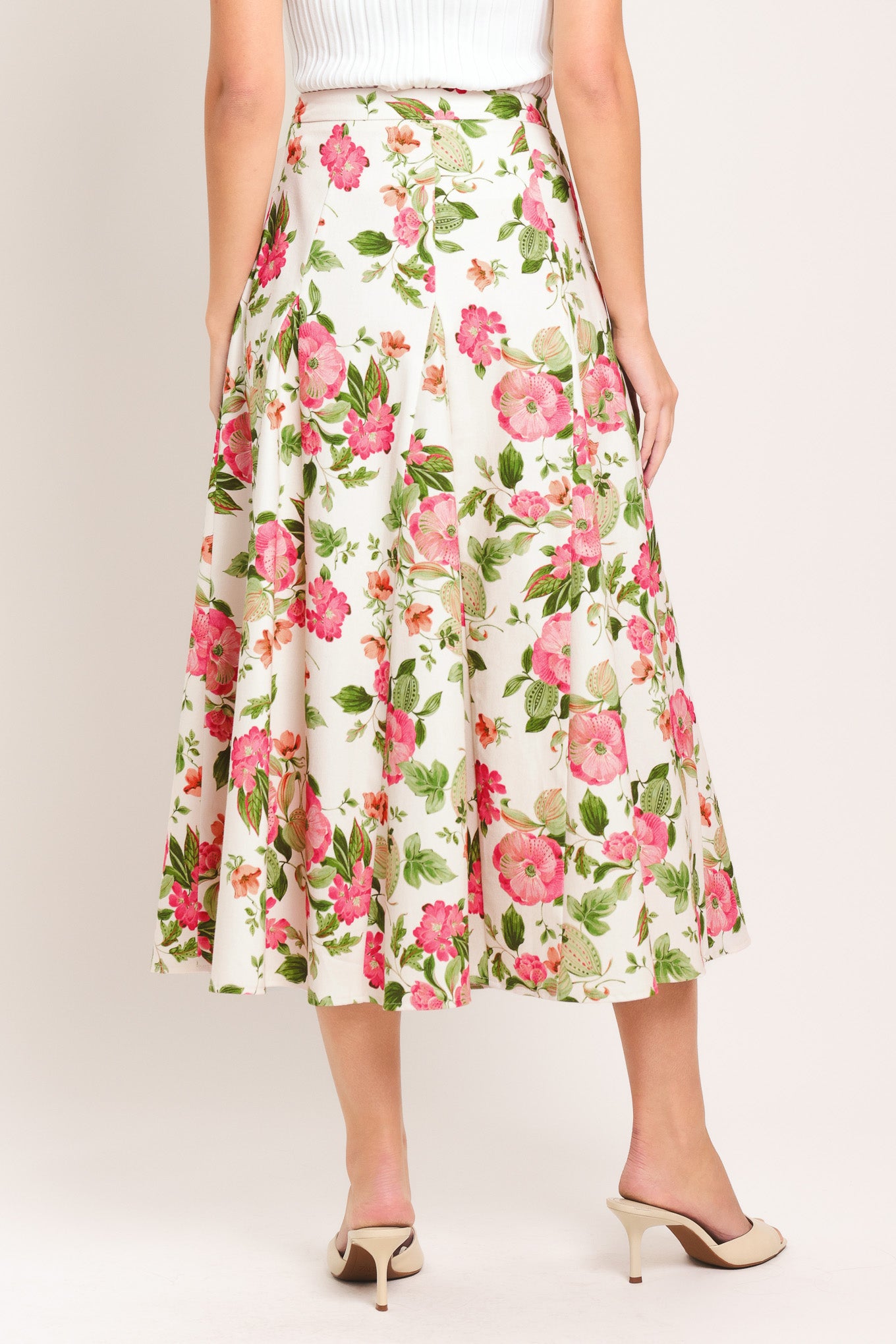 Woman wearing a floral midi skirt with side zipper closure | Flying Tomato