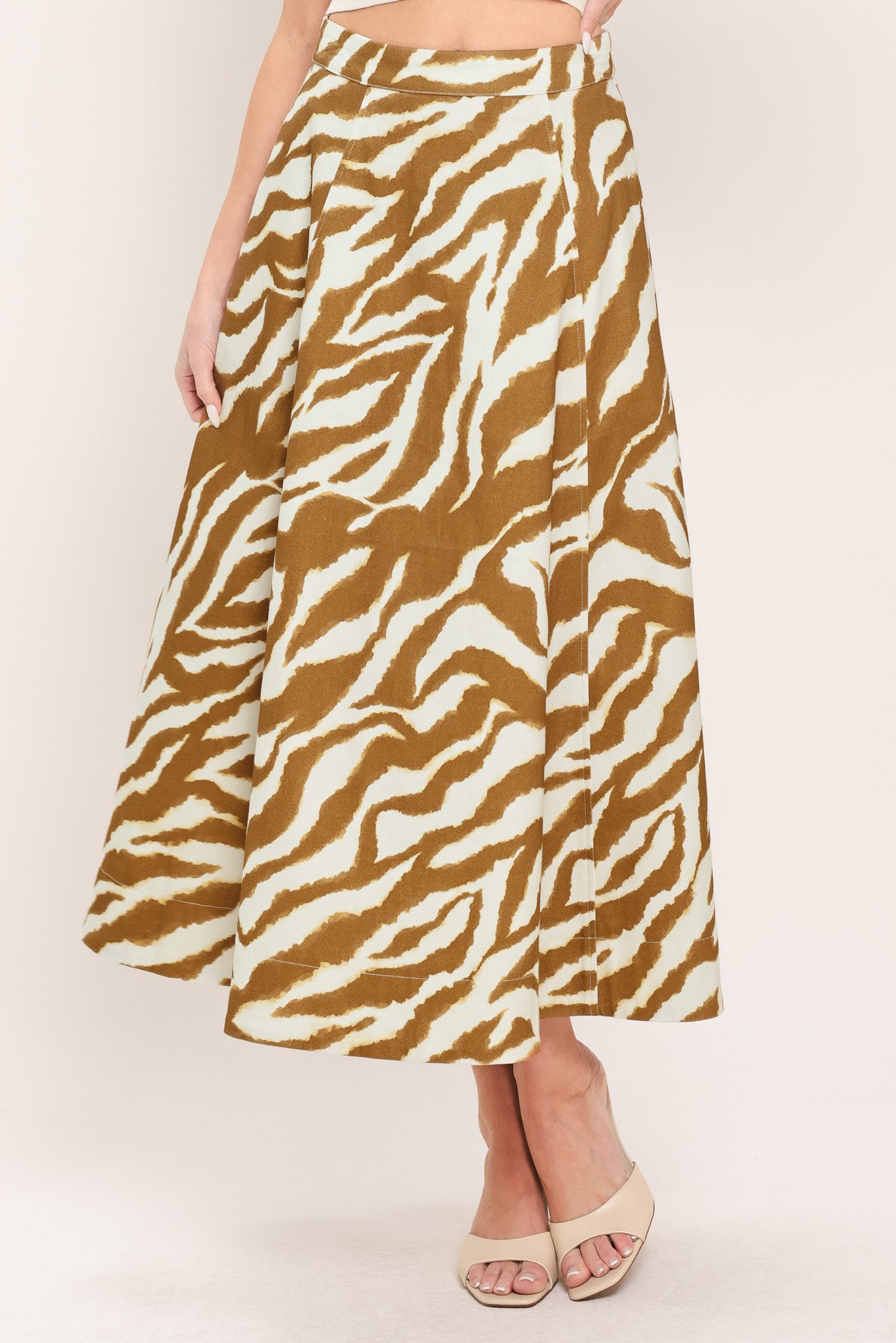 Woman wearing a light brown and taupe midi skirt with back zipper closure | Flying Tomato