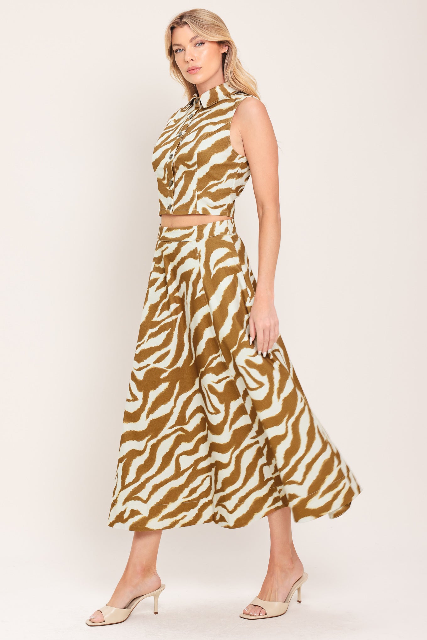 Woman wearing a light brown and taupe midi skirt with pockets and back zipper closure | Flying Tomato