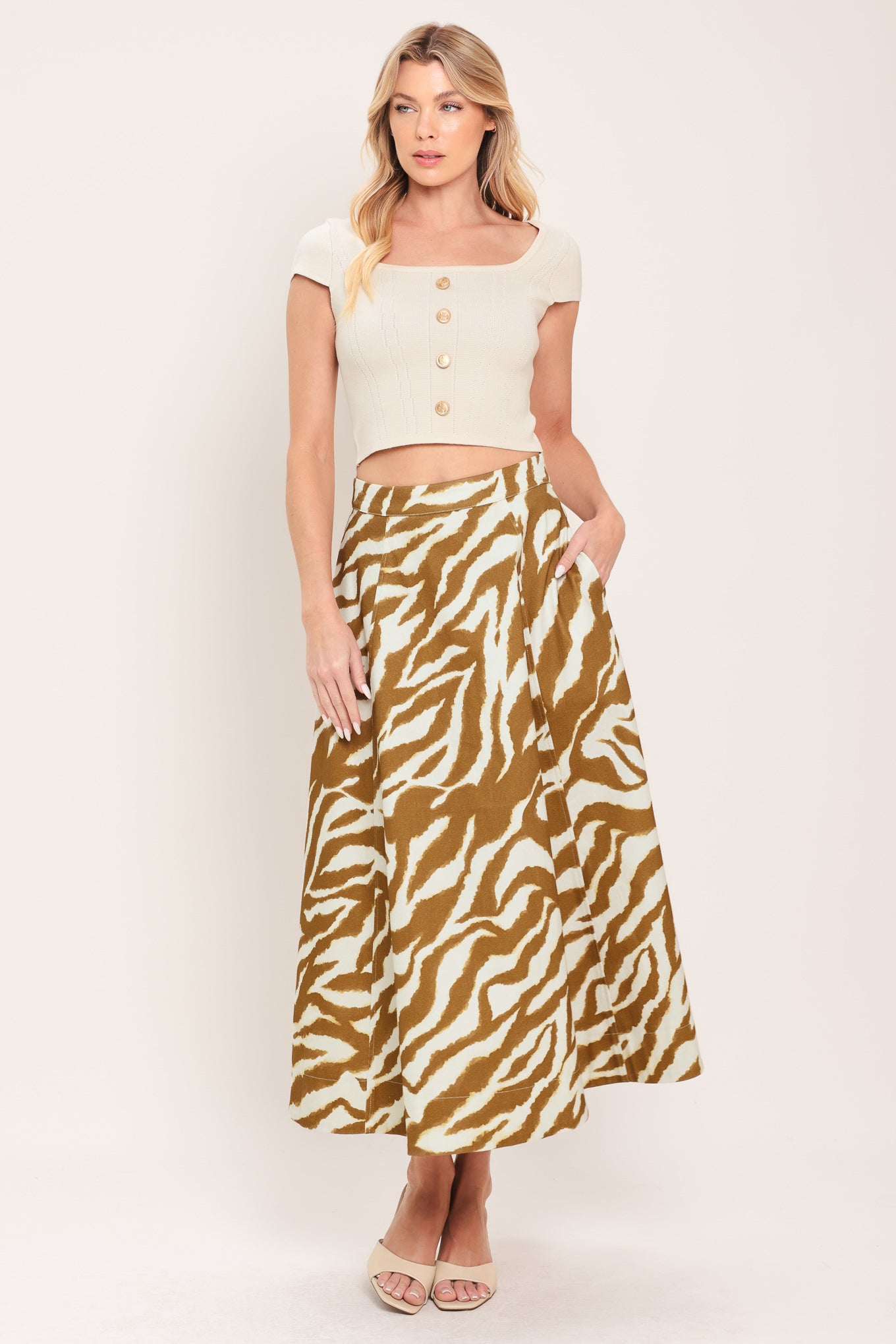 Woman wearing a light brown and taupe midi skirt with back zipper closure | Flying Tomato