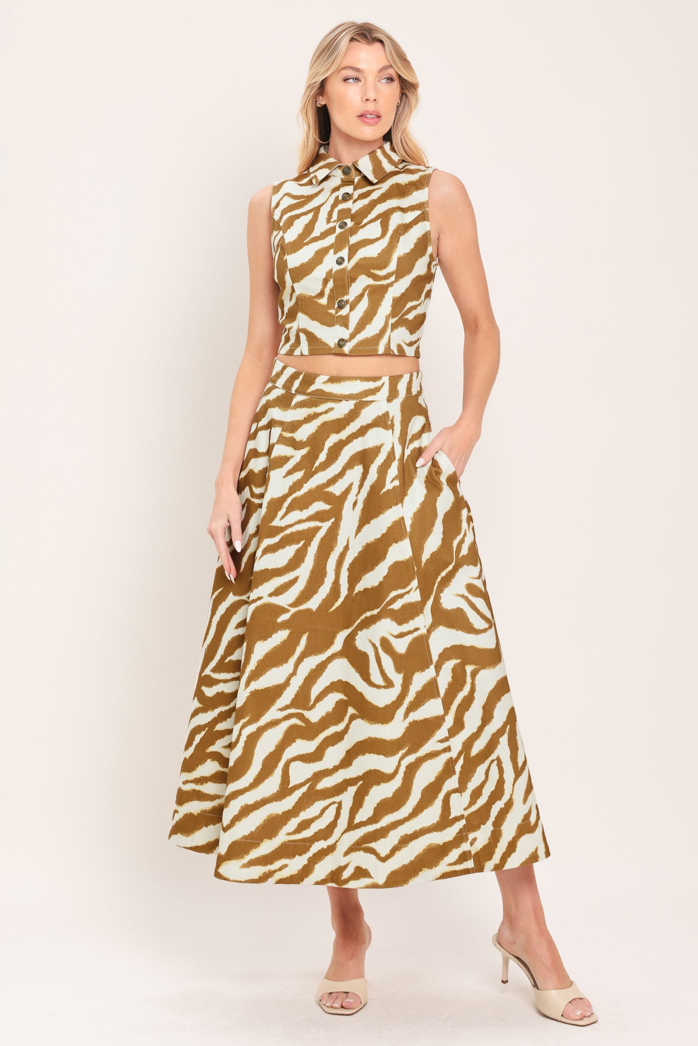 Woman wearing a light brown and taupe midi skirt with pockets and back zipper closure | Flying Tomato