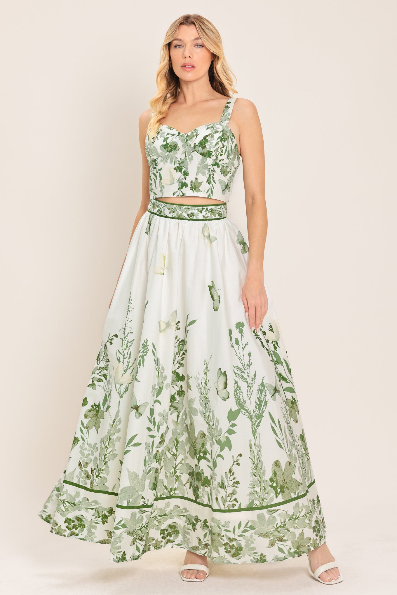 Woman wearing a long floral maxi skirt with green accents | Flying Tomato