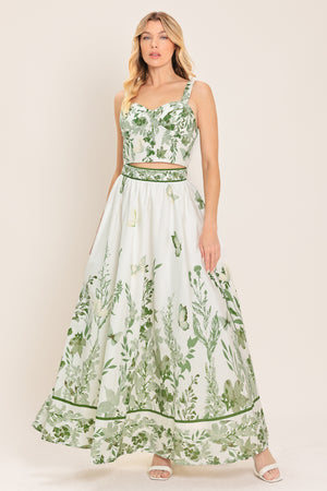Woman wearing a long floral maxi skirt with green accents | Flying Tomato