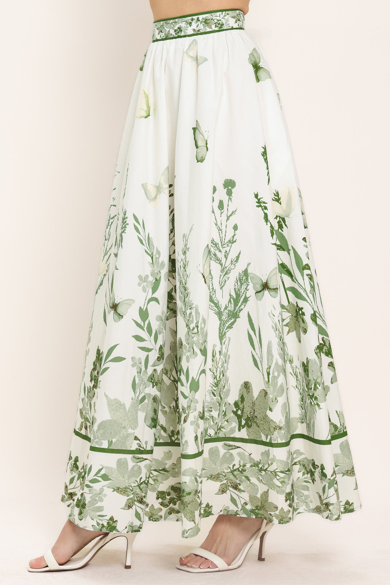 Woman wearing a long floral maxi skirt with green accents | Flying Tomato