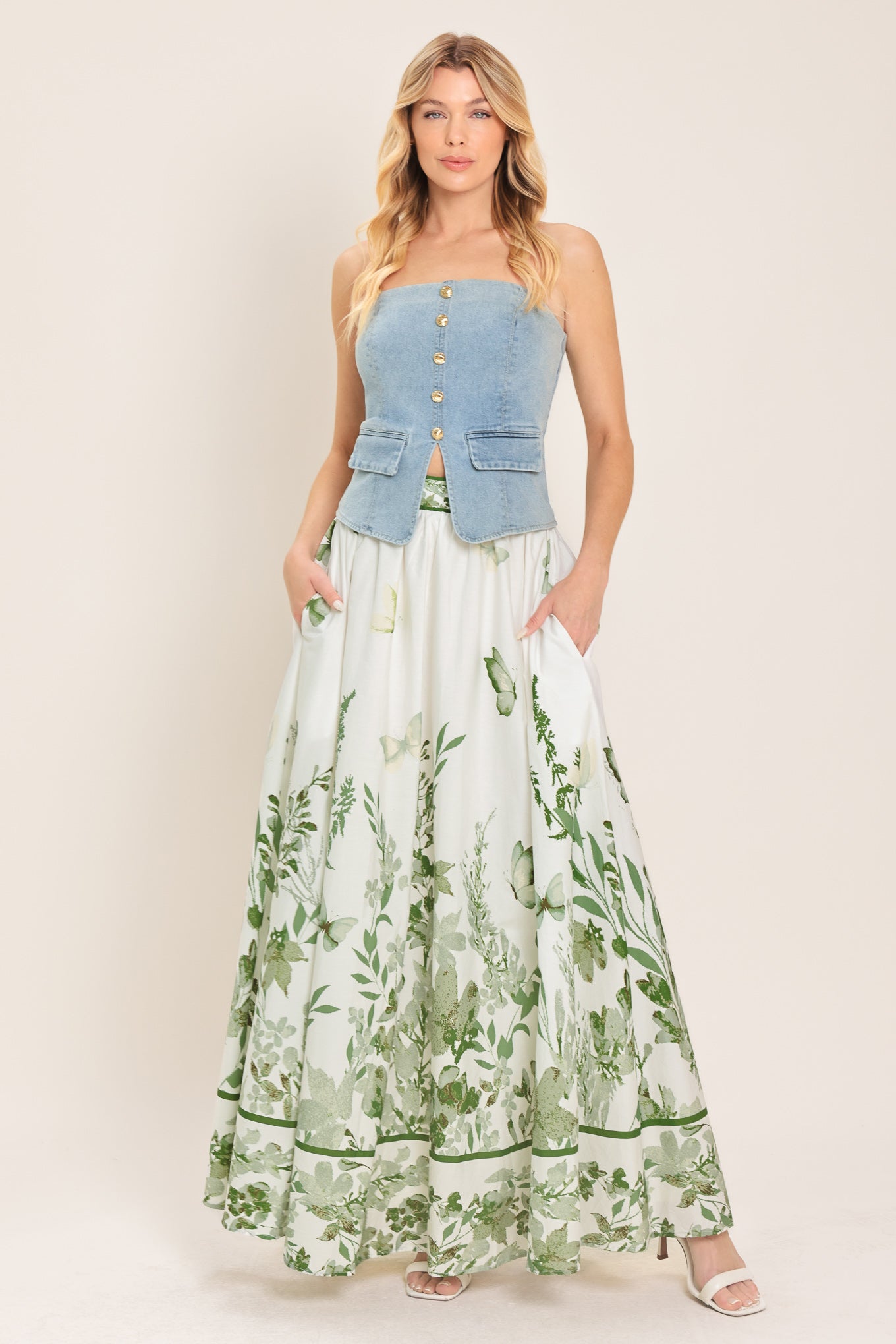 Woman wearing a long floral maxi skirt with green accents | Flying Tomato