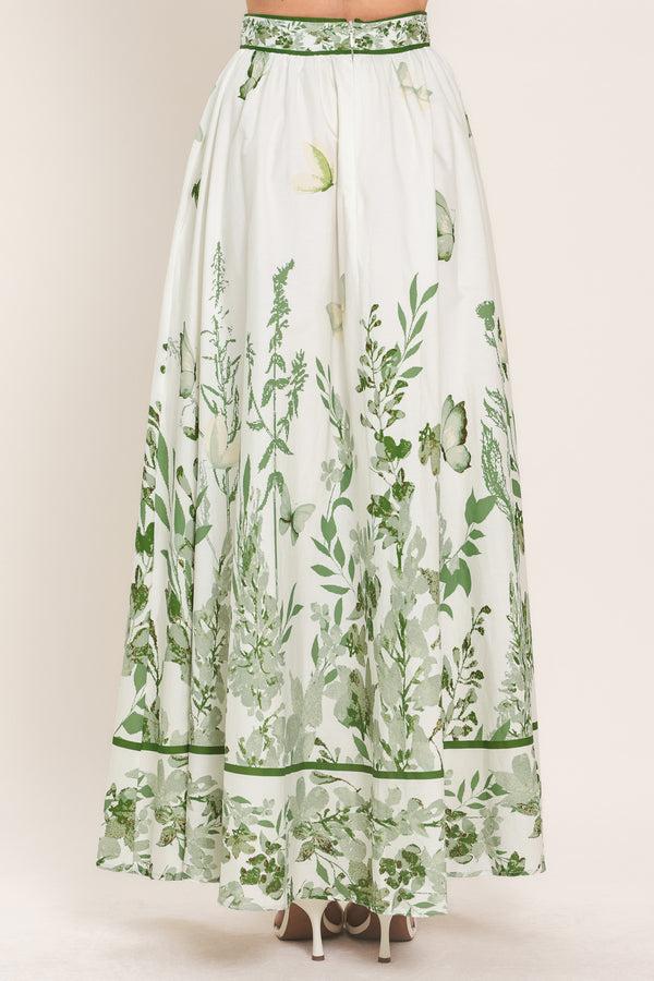 Woman wearing a long floral maxi skirt with green accents | Flying Tomato