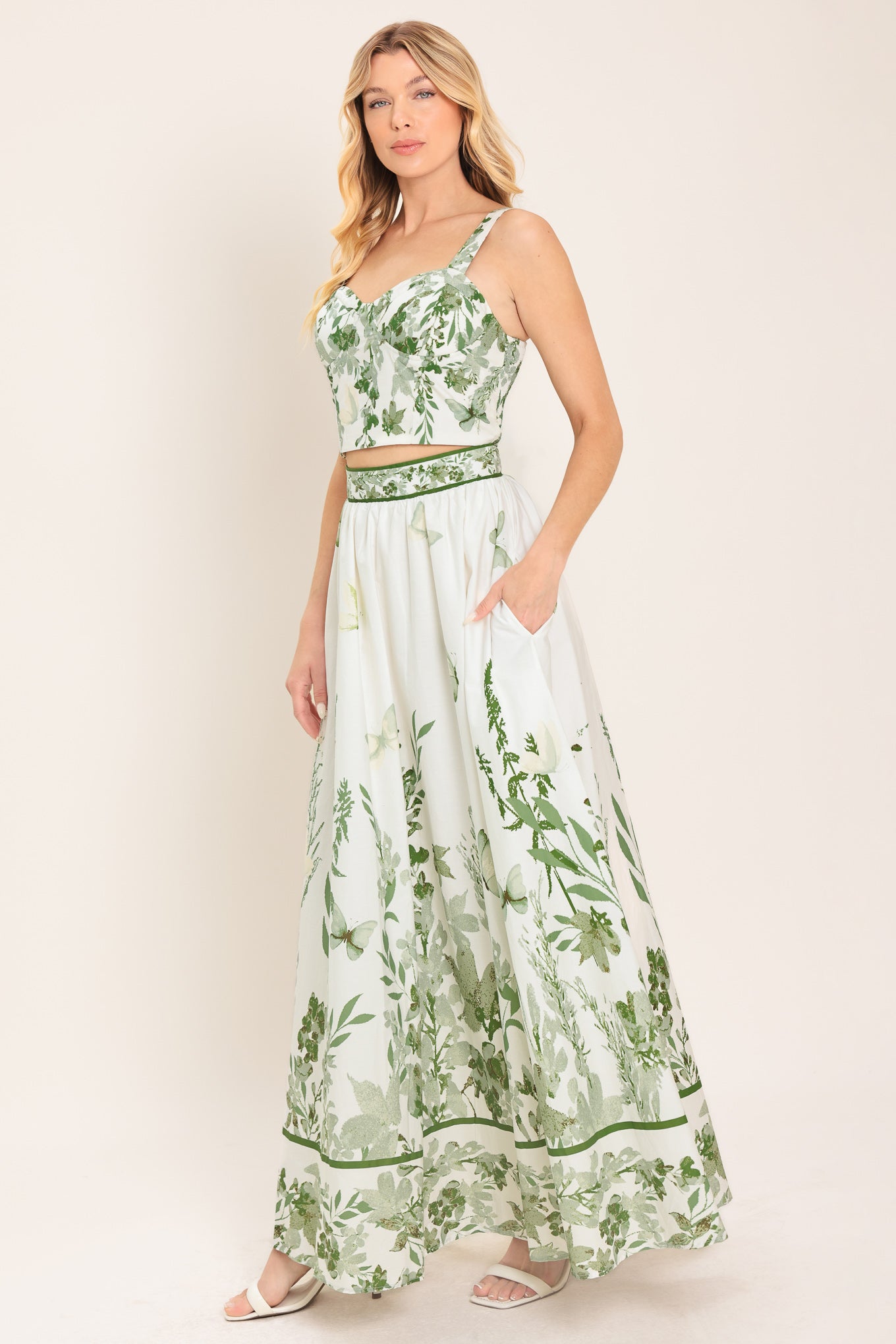 Woman wearing a long floral maxi skirt with green accents | Flying Tomato