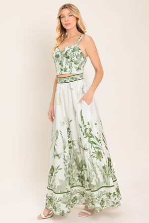 Woman wearing a long floral maxi skirt with green accents | Flying Tomato