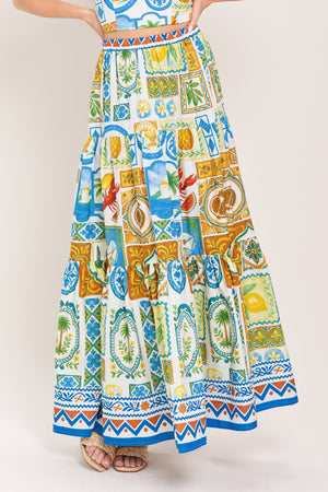 Woman wearing a maxi skirt with elastic waist and tiers featuring a bold, summer print | Flying Tomato