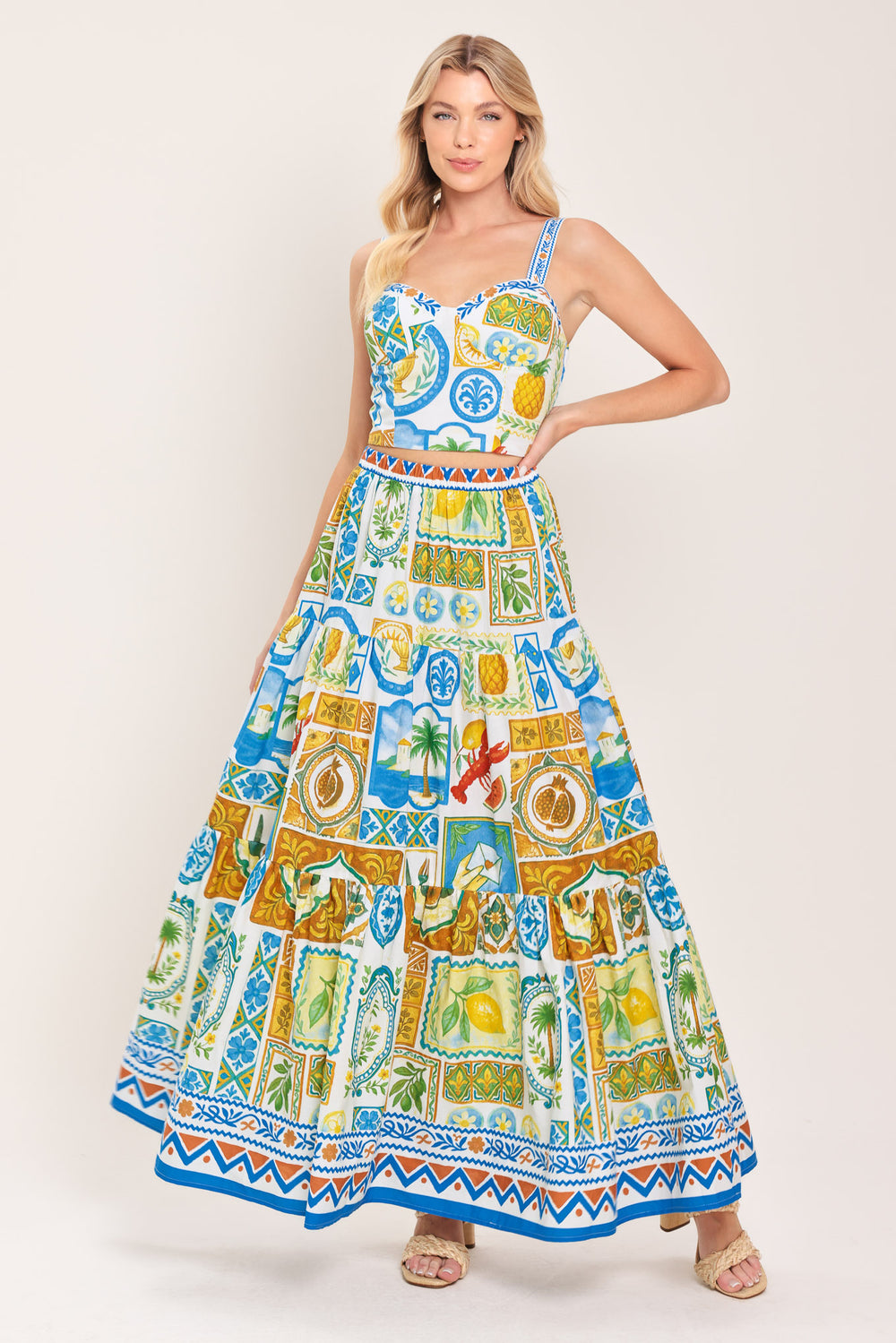 Woman wearing a maxi skirt with elastic waist and tiers featuring a bold, summer print | Flying Tomato