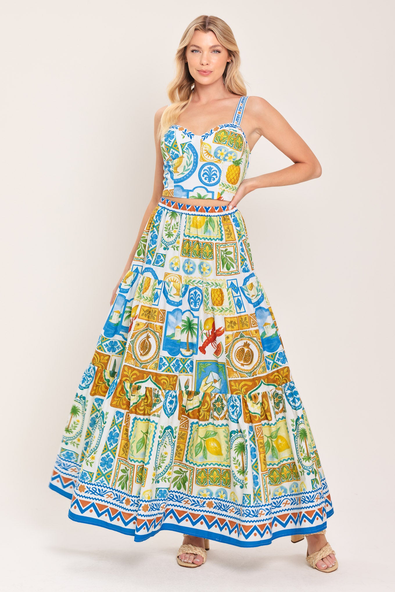 Woman wearing a maxi skirt with elastic waist and tiers featuring a bold, summer print | Flying Tomato