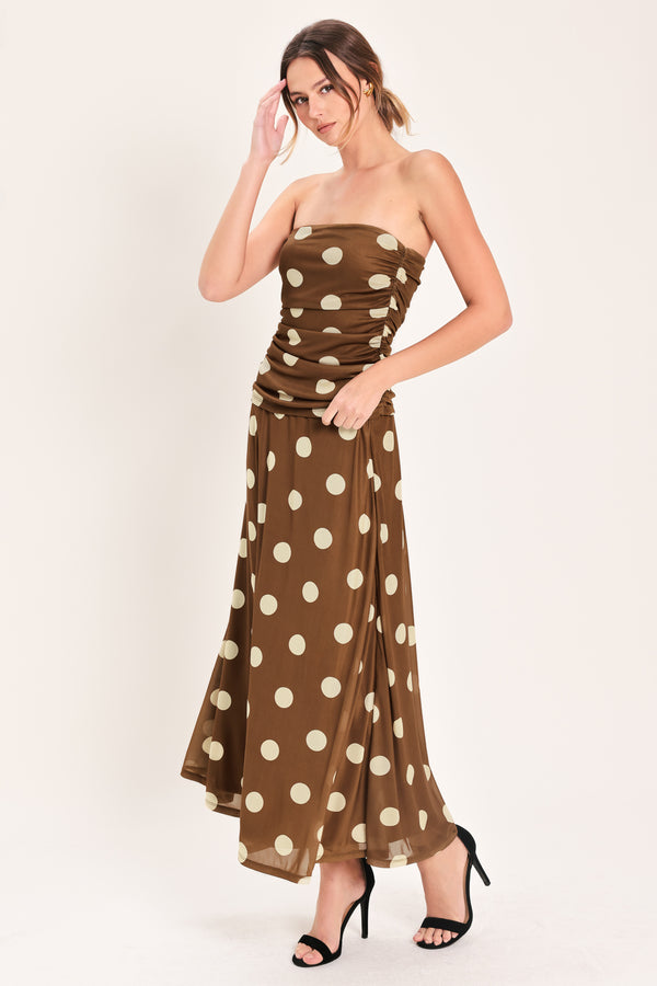 Woman wearing a brown polka dot midi skirt with elastic waist | Flying Tomato