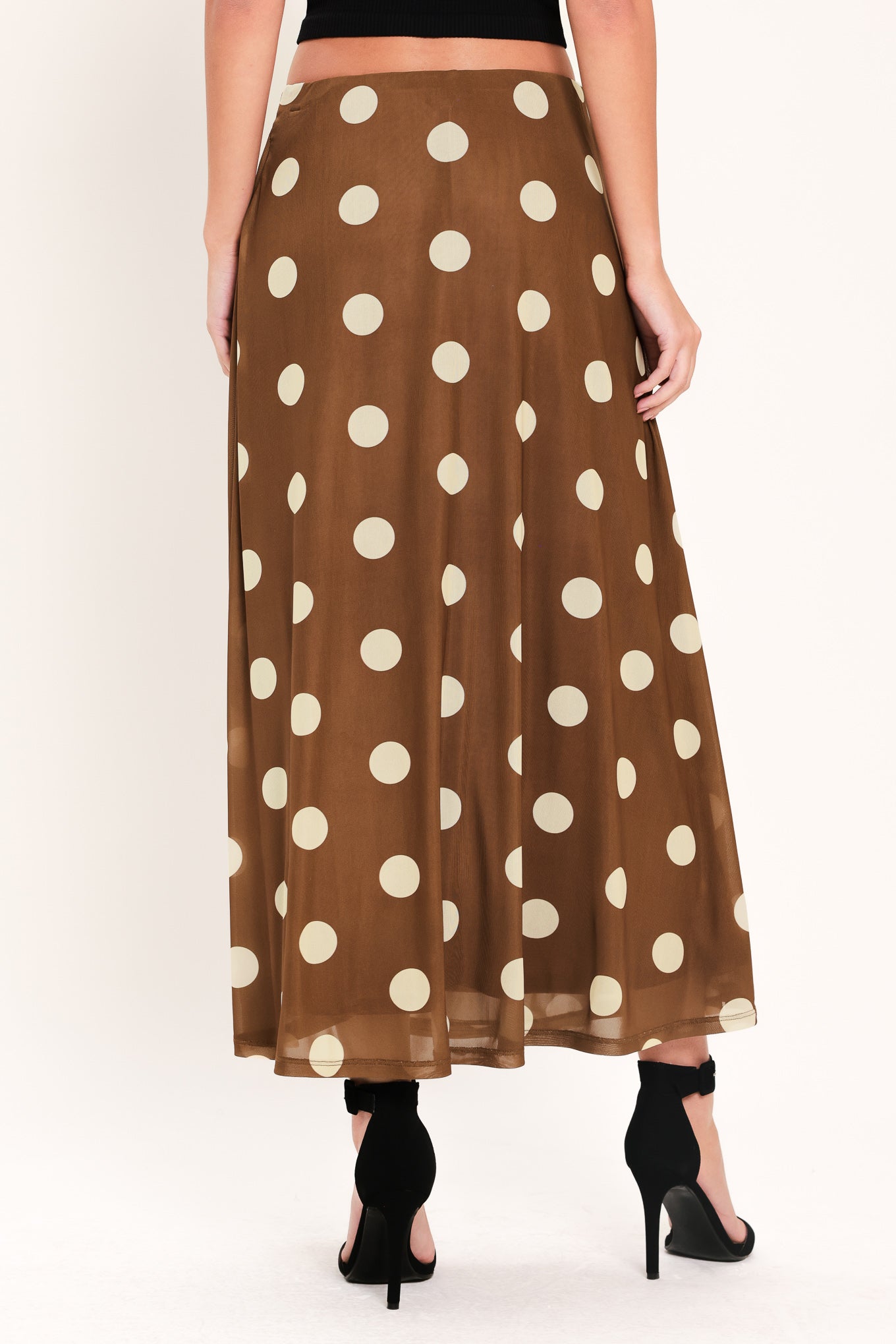 Woman wearing a brown polka dot midi skirt with elastic waist | Flying Tomato