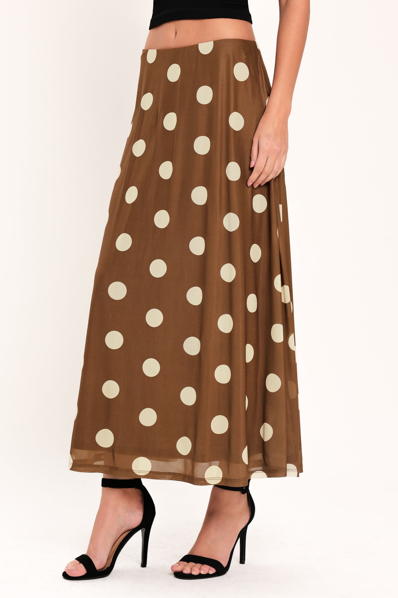 Woman wearing a brown polka dot midi skirt with elastic waist | Flying Tomato
