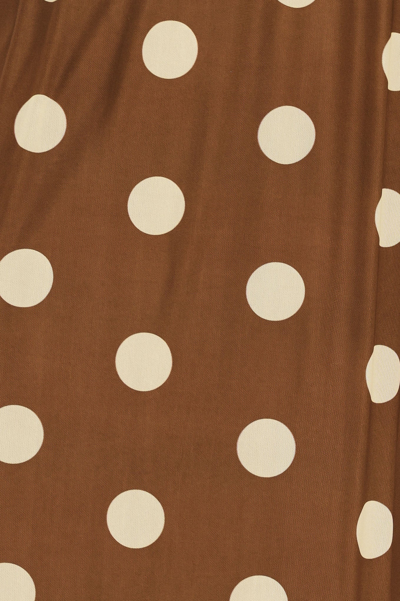 Woman wearing a brown polka dot midi skirt with elastic waist | Flying Tomato