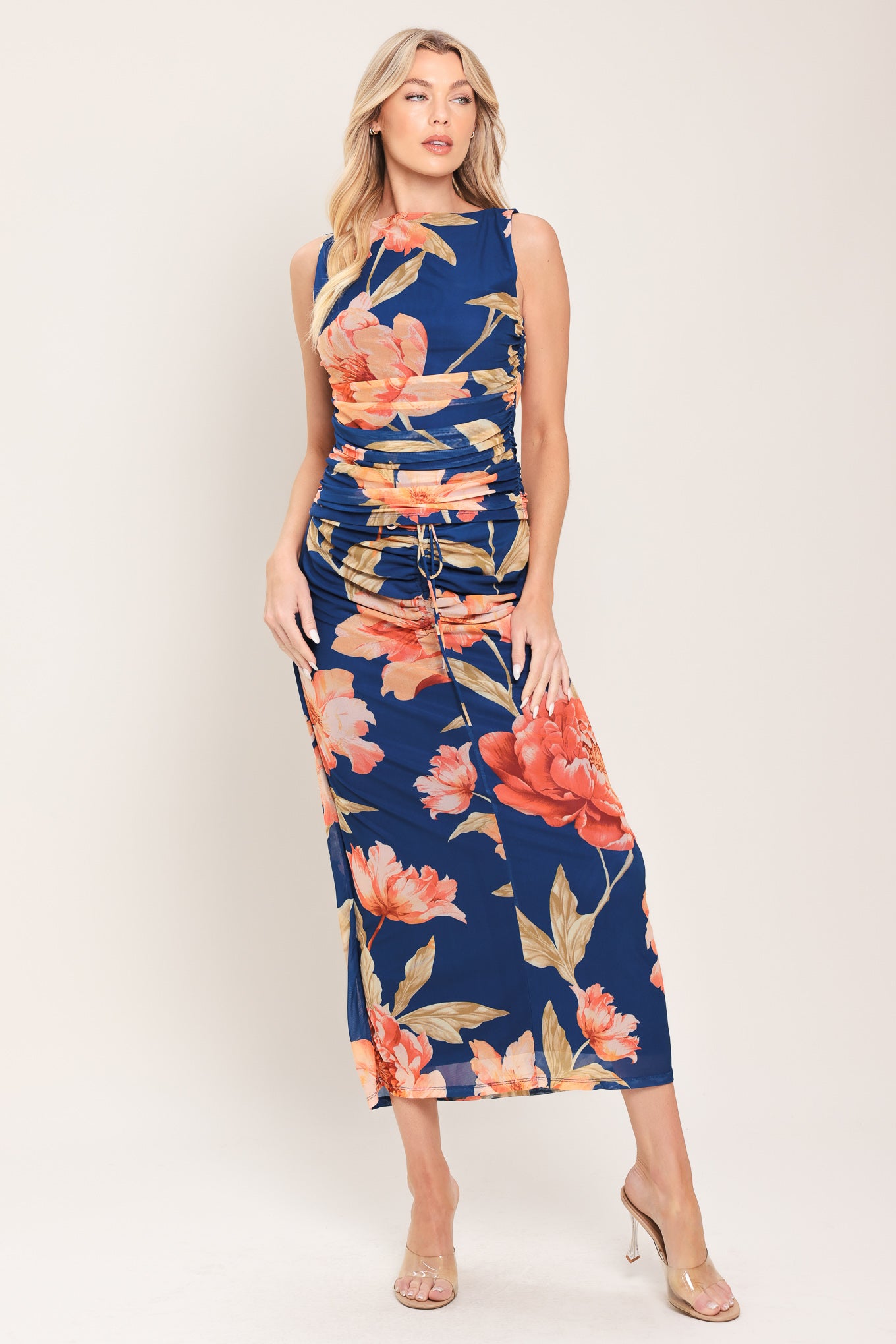 Woman wearing a navy blue with coral flowers power mesh midi skirt with front center shirring with tie and back zipper closure | Flying Tomato
