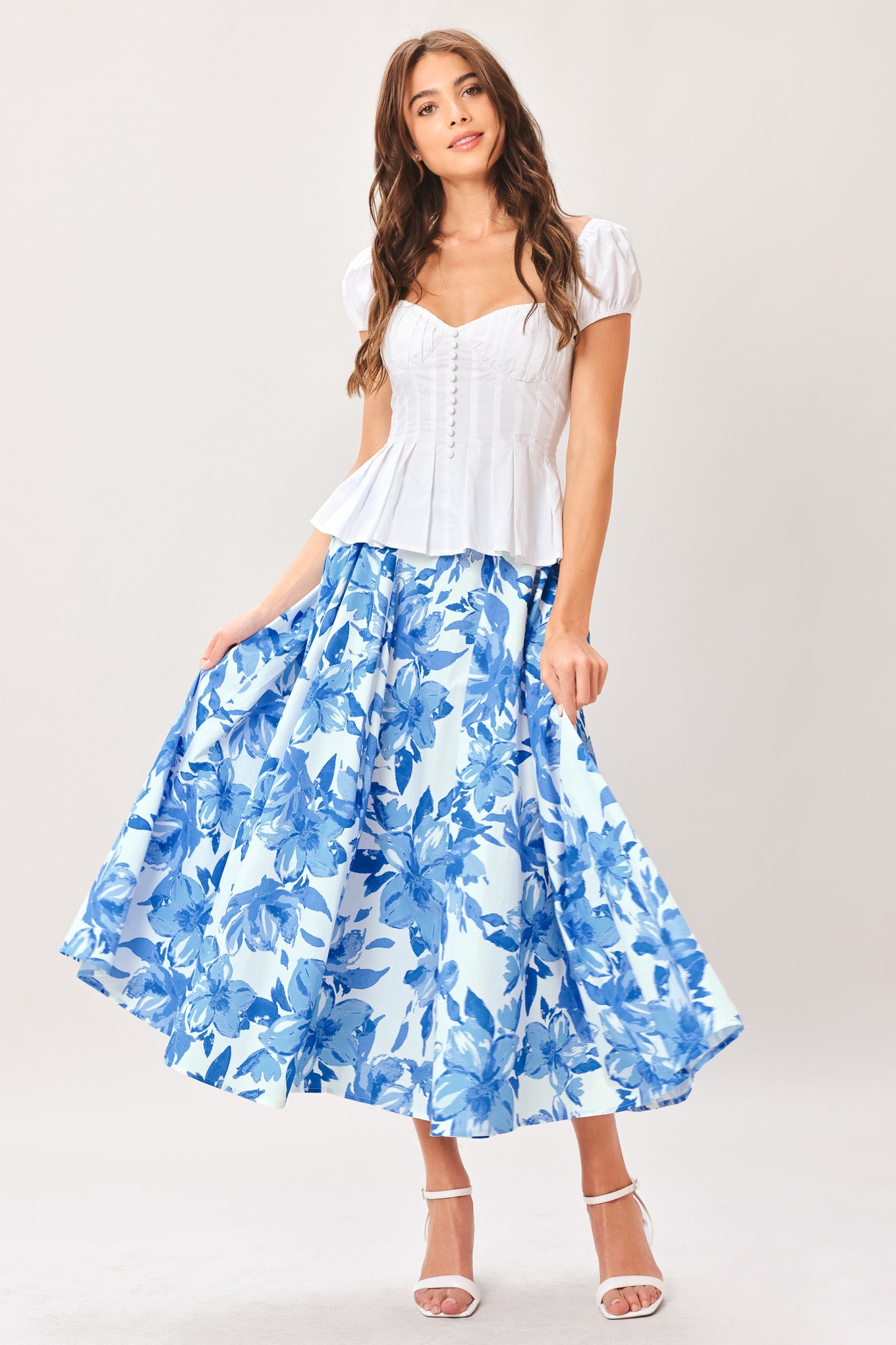 Woman wearing a blue floral full circle skirt with side zipper closure | Flying Tomato