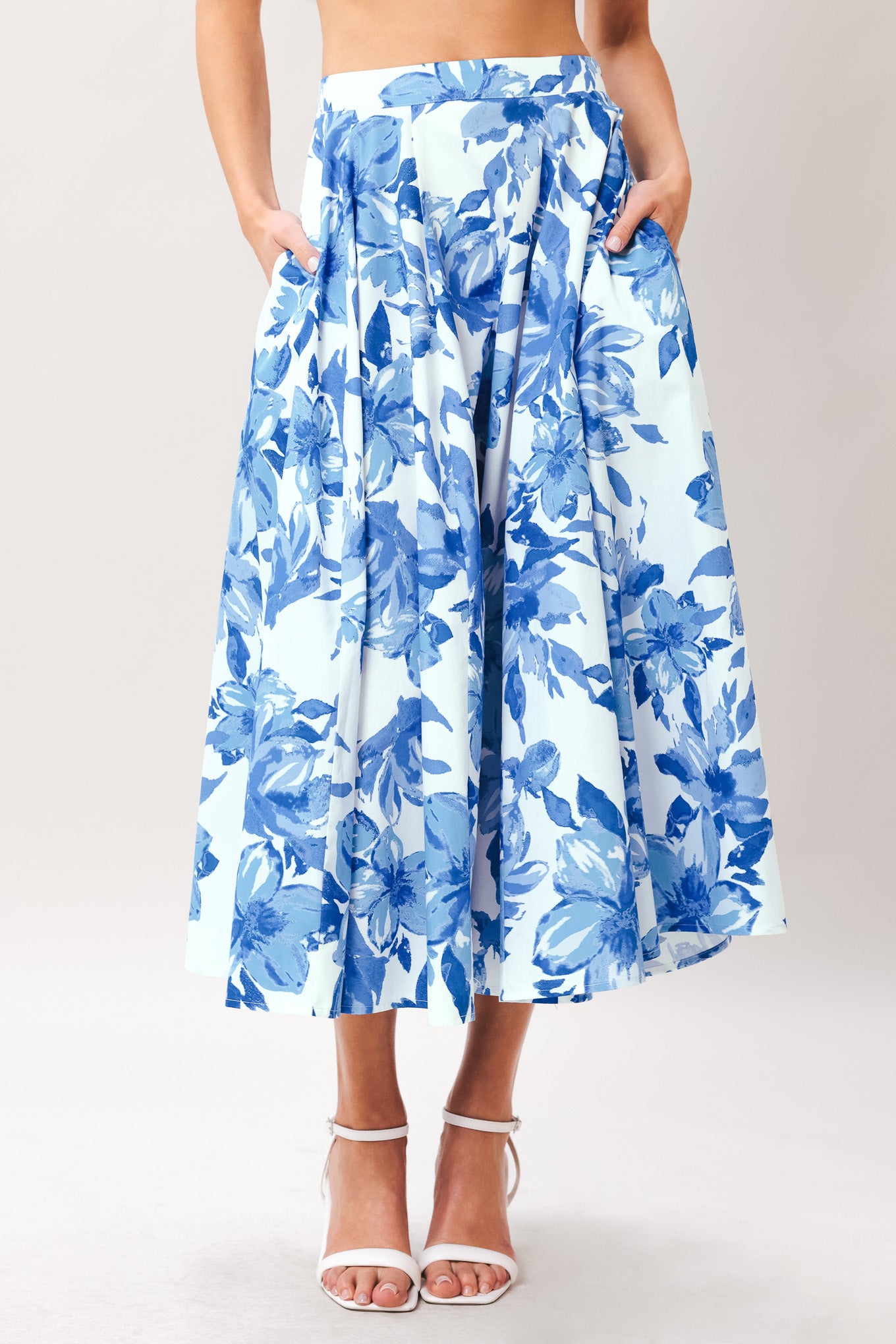 Woman wearing a blue floral full circle skirt with side zipper closure | Flying Tomato