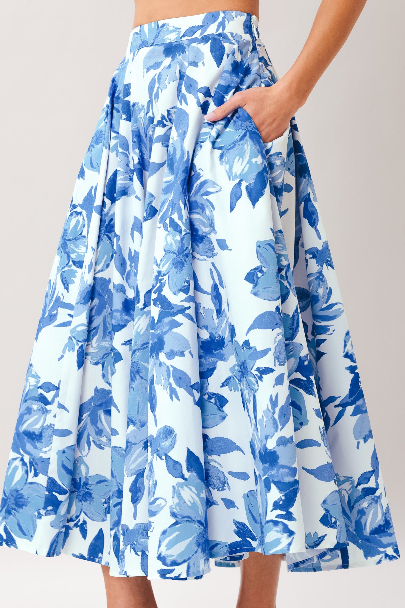 Woman wearing a blue floral full circle skirt with side zipper closure | Flying Tomato