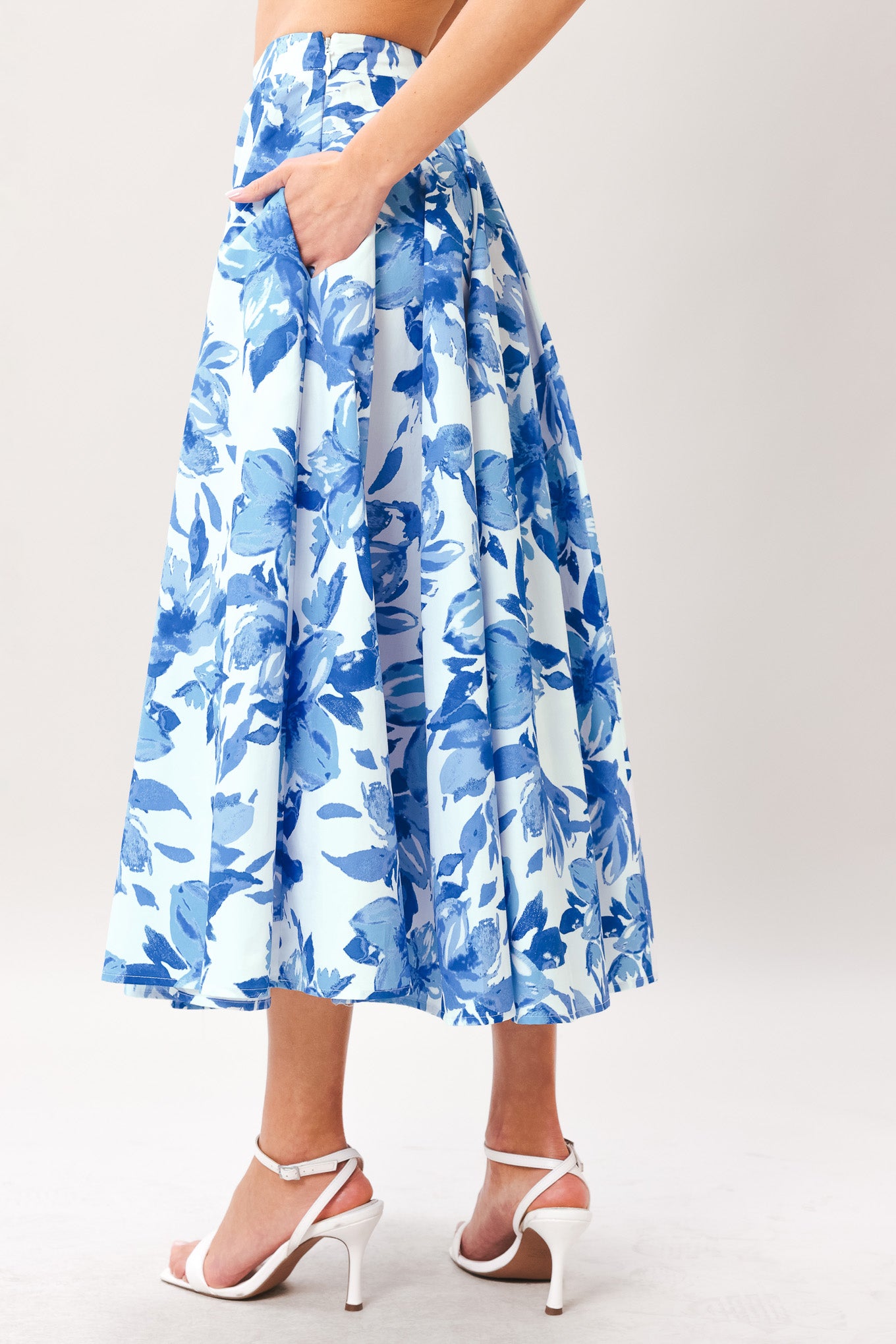 Woman wearing a blue floral full circle skirt with side zipper closure | Flying Tomato
