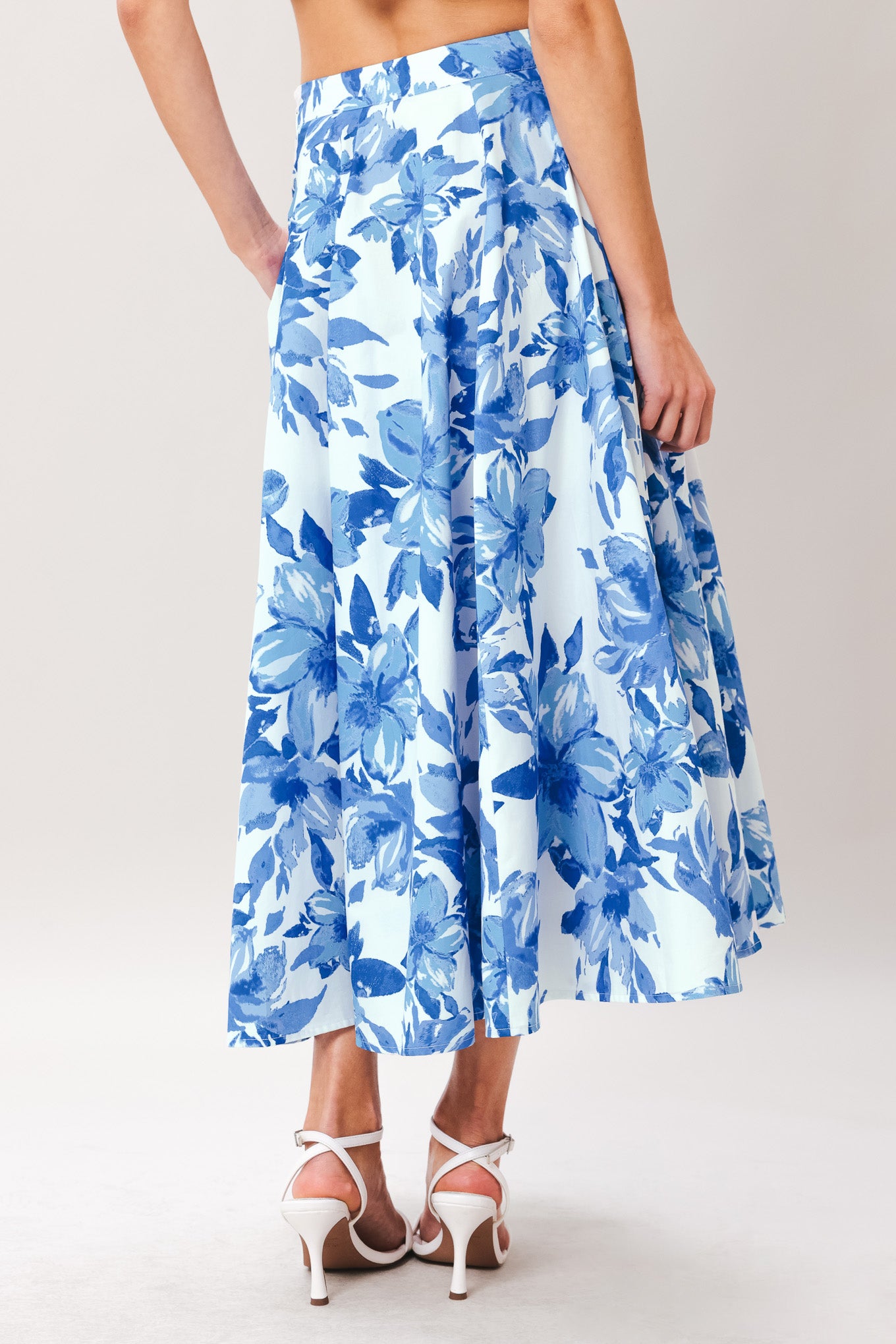 Woman wearing a blue floral full circle skirt with side zipper closure | Flying Tomato