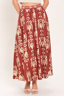 Woman wearing a burgundy ankle skirt with beige floral pattern | Flying Tomato