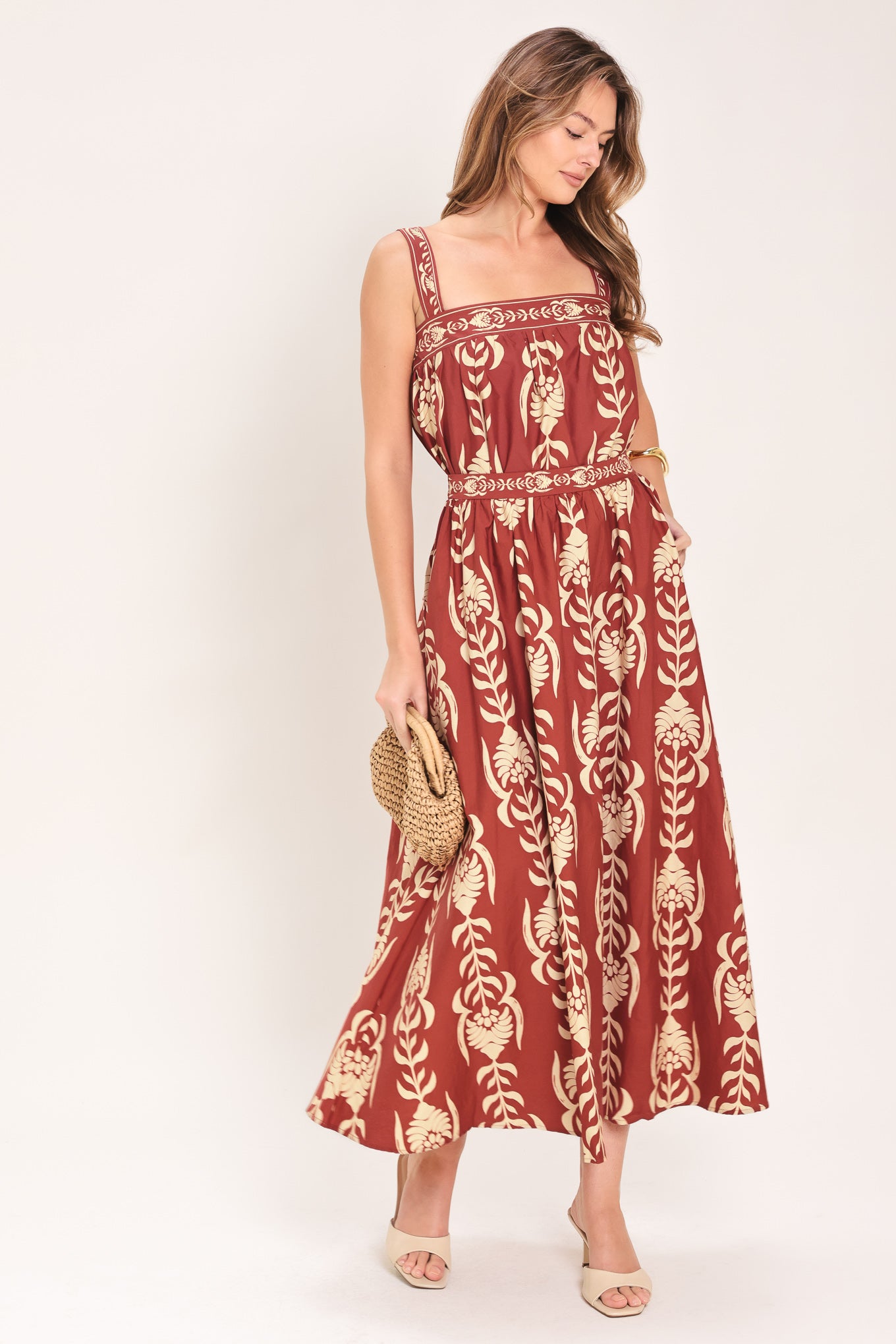 Woman wearing a burgundy ankle skirt with beige floral pattern | Flying Tomato